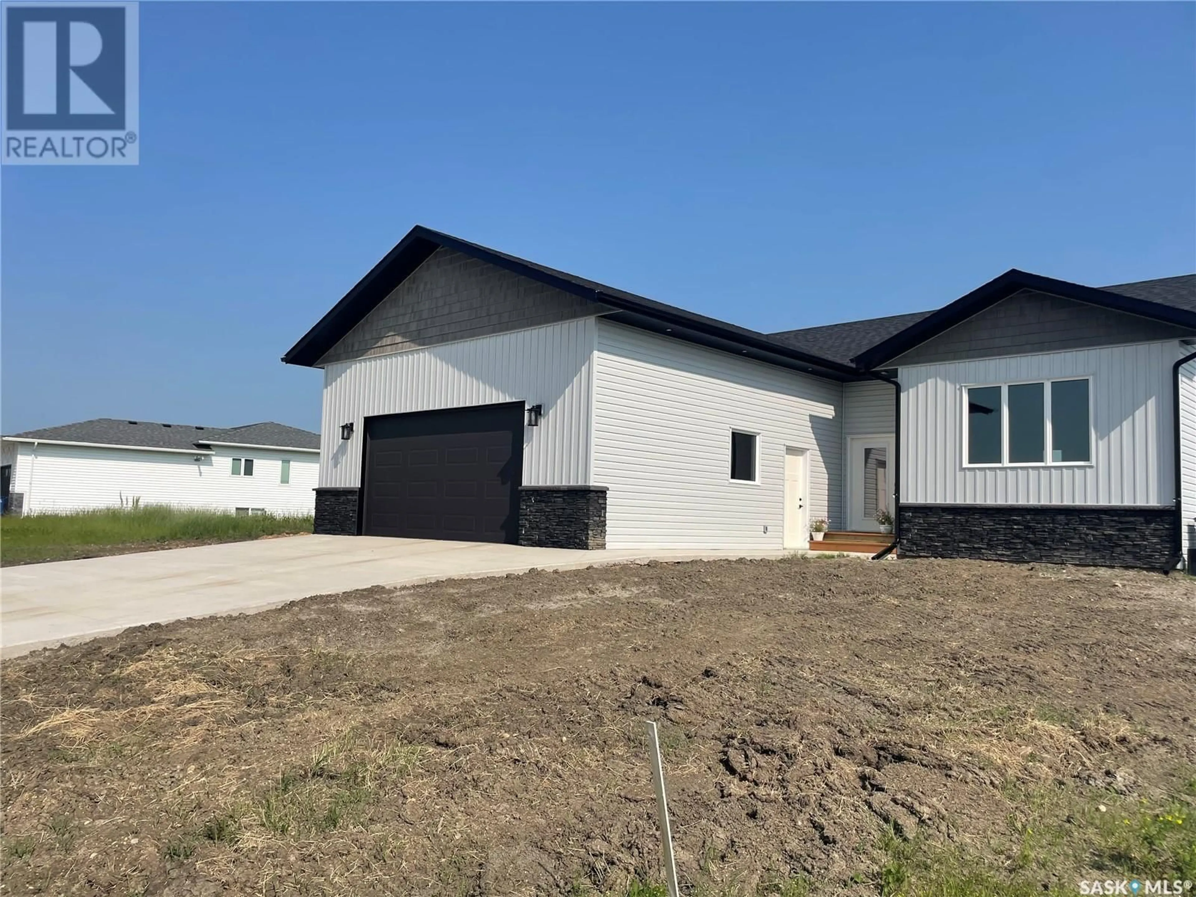 Home with vinyl exterior material, street for 715 DOGHIDE DRIVE, Tisdale Saskatchewan S0E1T0