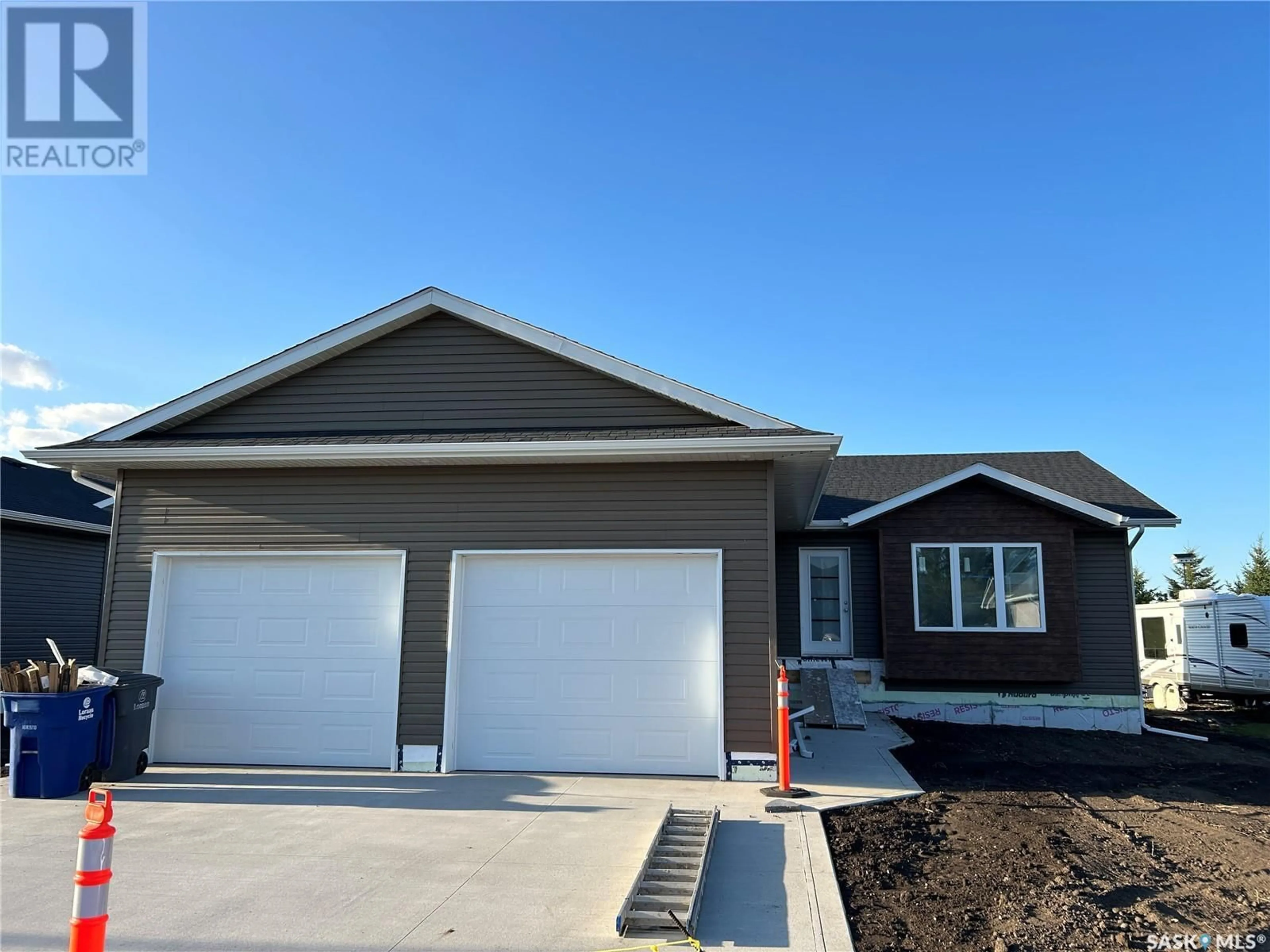 Home with vinyl exterior material, street for 216 KESTREL COURT, Rosthern Saskatchewan S0K3R0
