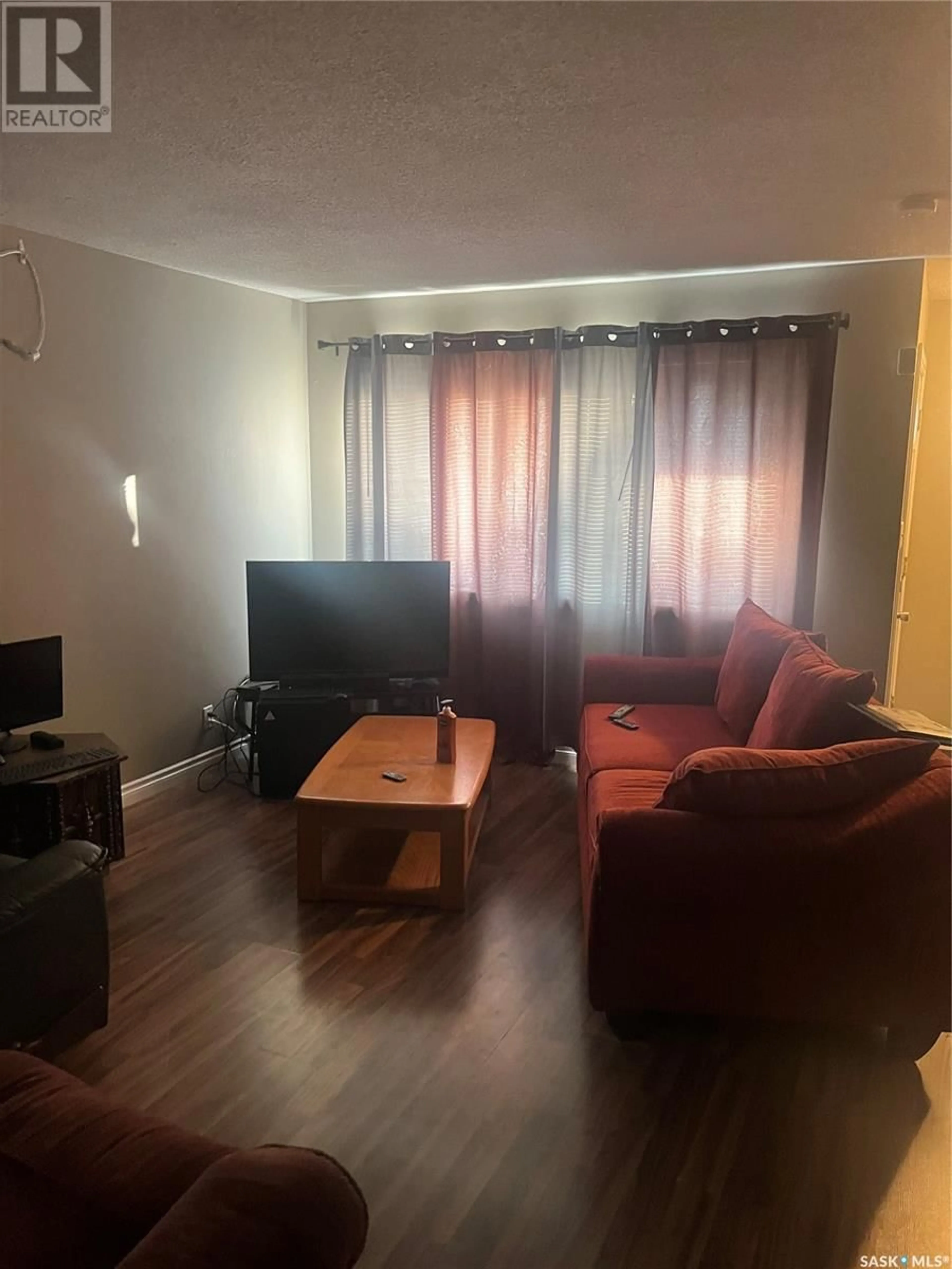 Living room with furniture, wood/laminate floor for 653 DONALD STREET, Esterhazy Saskatchewan S0A0X0