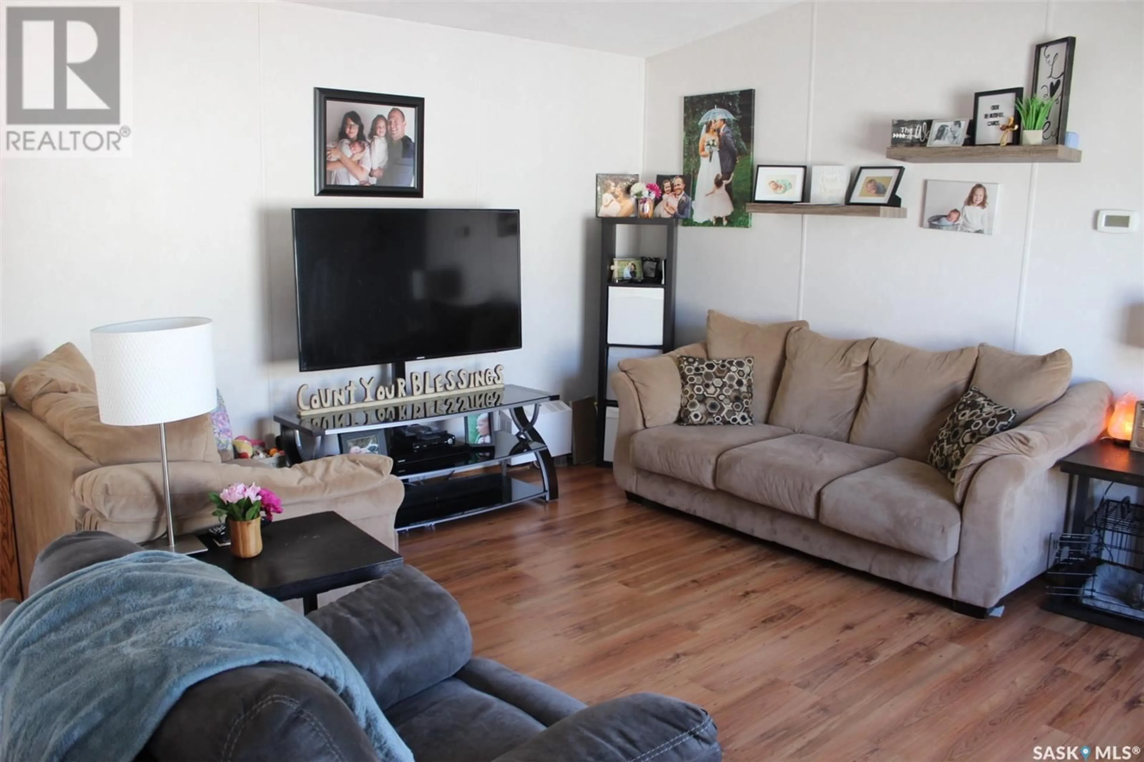 Living room with furniture, wood/laminate floor for SW - 12 106 1ST AVENUE, Weyburn Saskatchewan S4H2J1