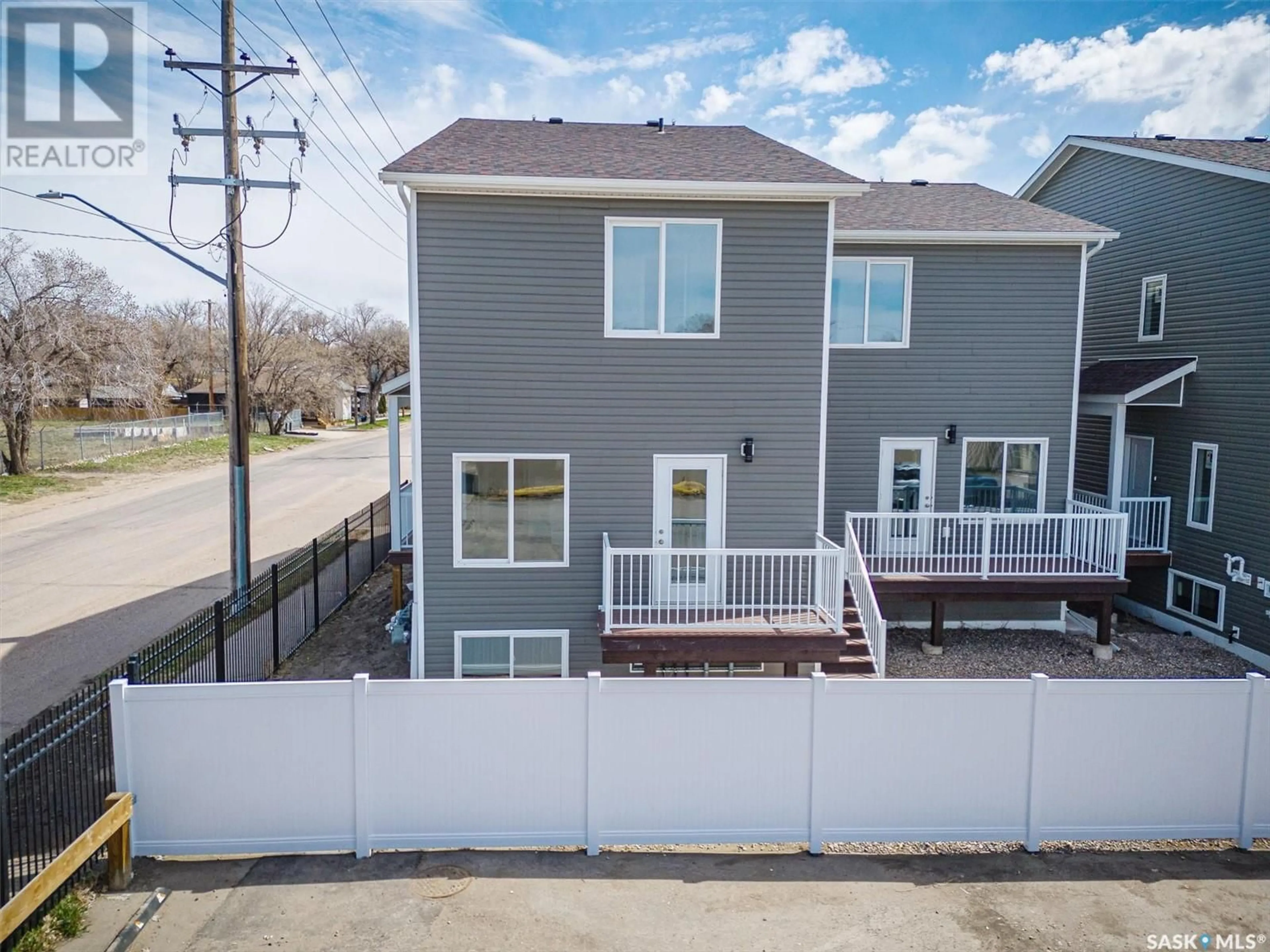 A pic from exterior of the house or condo, the fenced backyard for 423 L AVENUE S, Saskatoon Saskatchewan S7M5Y6