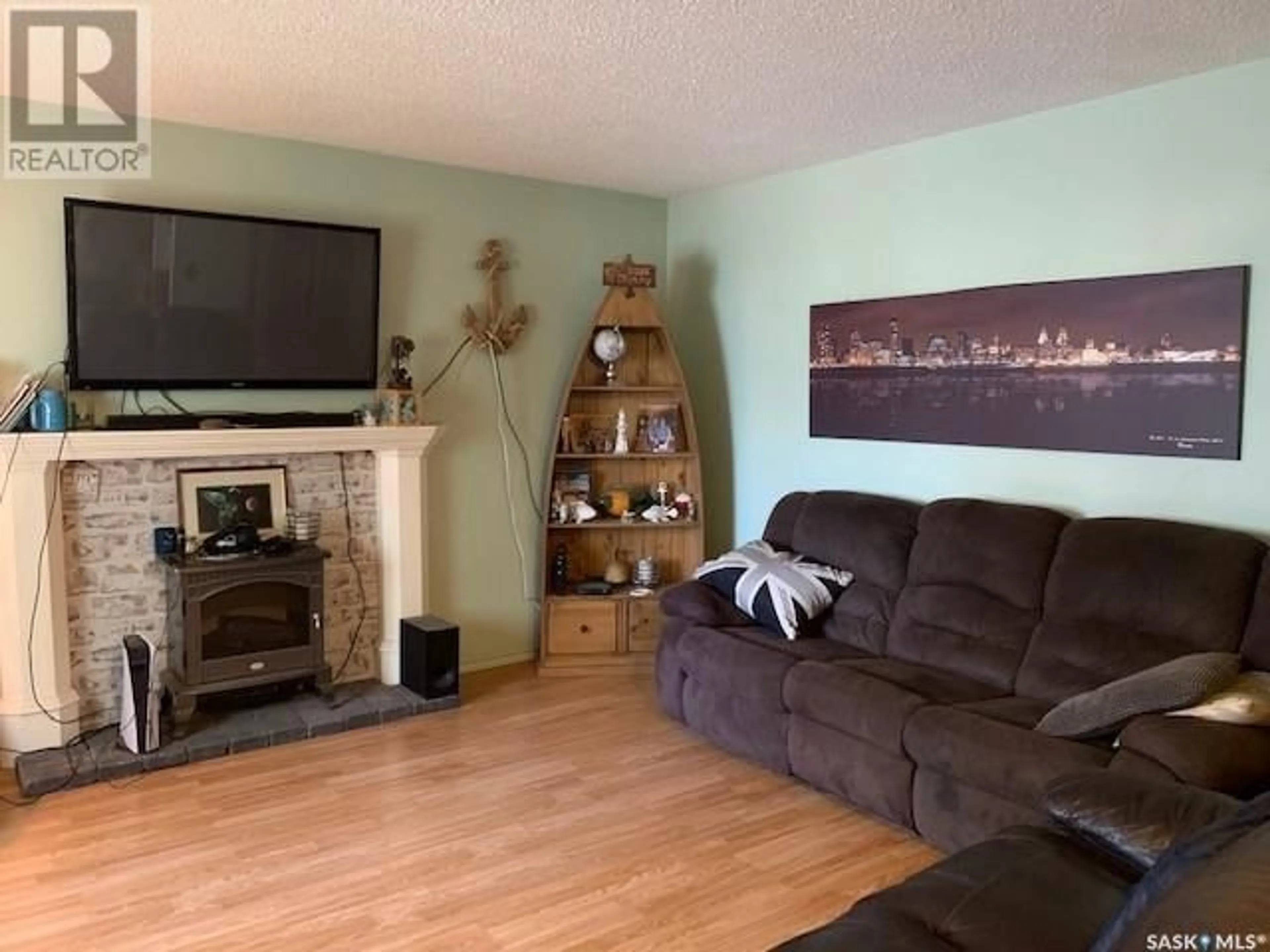 Living room with furniture, wood/laminate floor for 216 Second AVENUE W, Hafford Saskatchewan S0J1A0