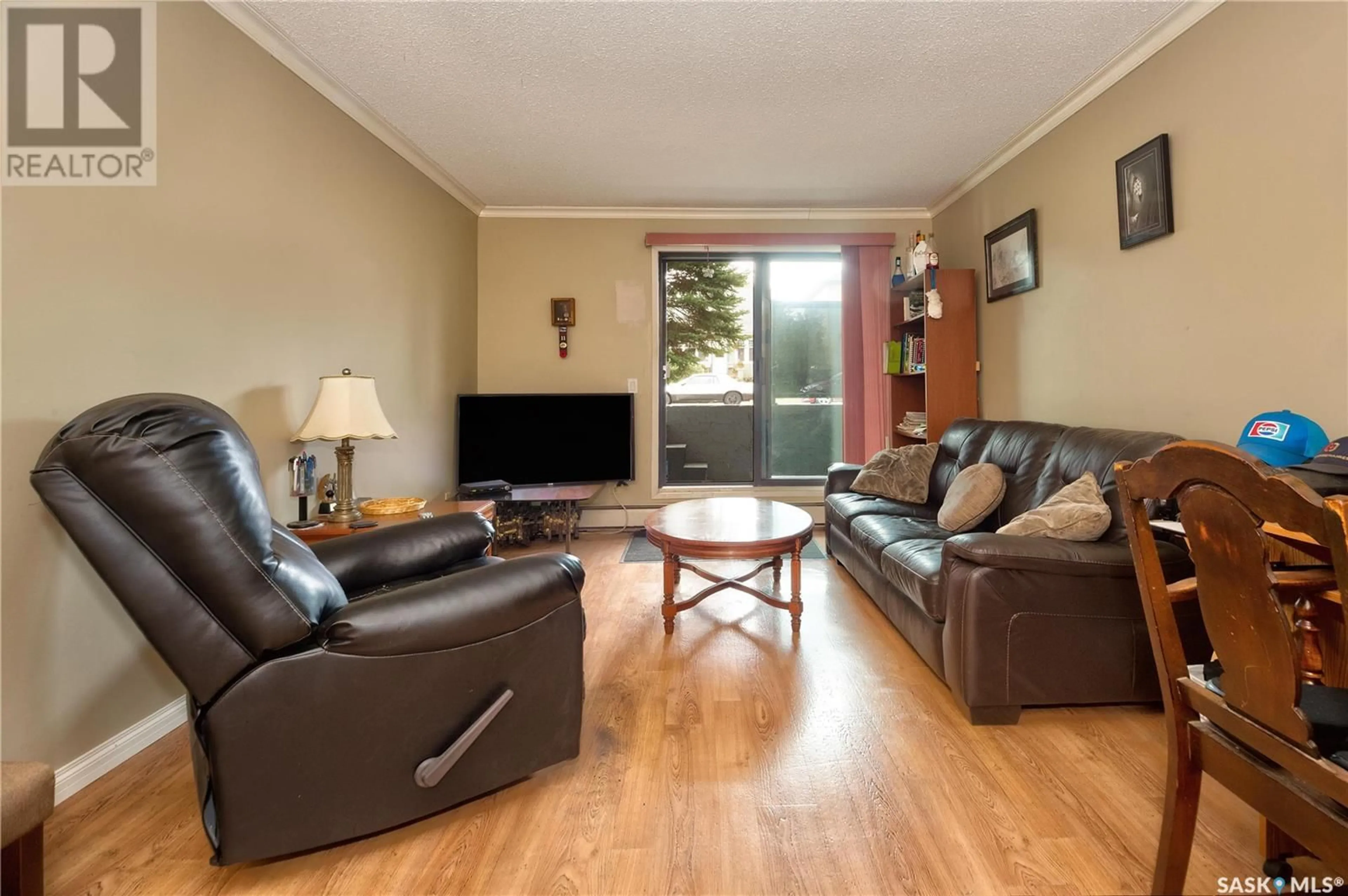 Living room with furniture, wood/laminate floor for 103 314 11th STREET E, Prince Albert Saskatchewan S6V1A5