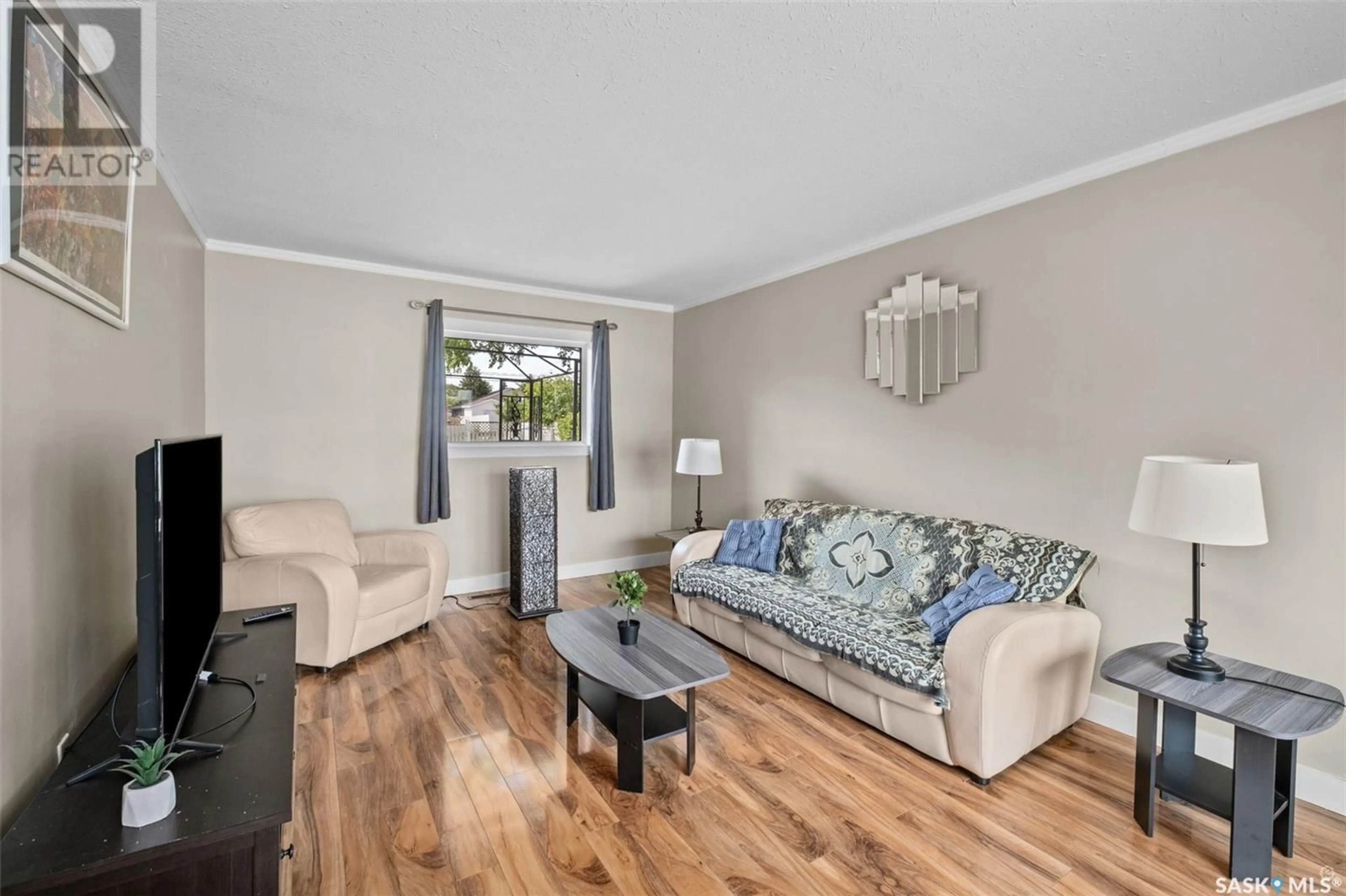 Living room with furniture, wood/laminate floor for 89 27TH STREET, Prince Albert Saskatchewan S6V1V7