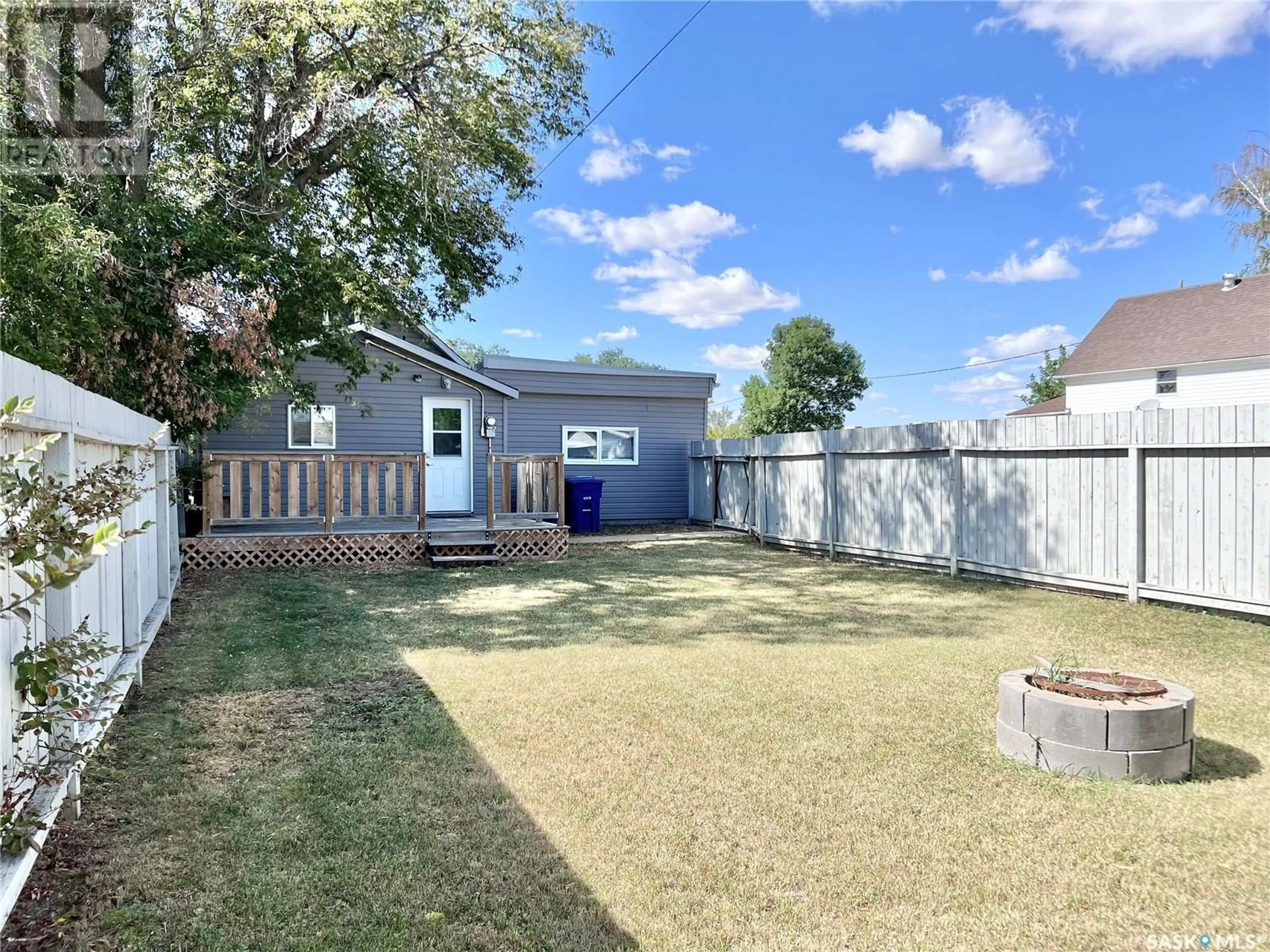 Frontside or backside of a home, the fenced backyard for 215 Simpson STREET, Outlook Saskatchewan S0L2N0