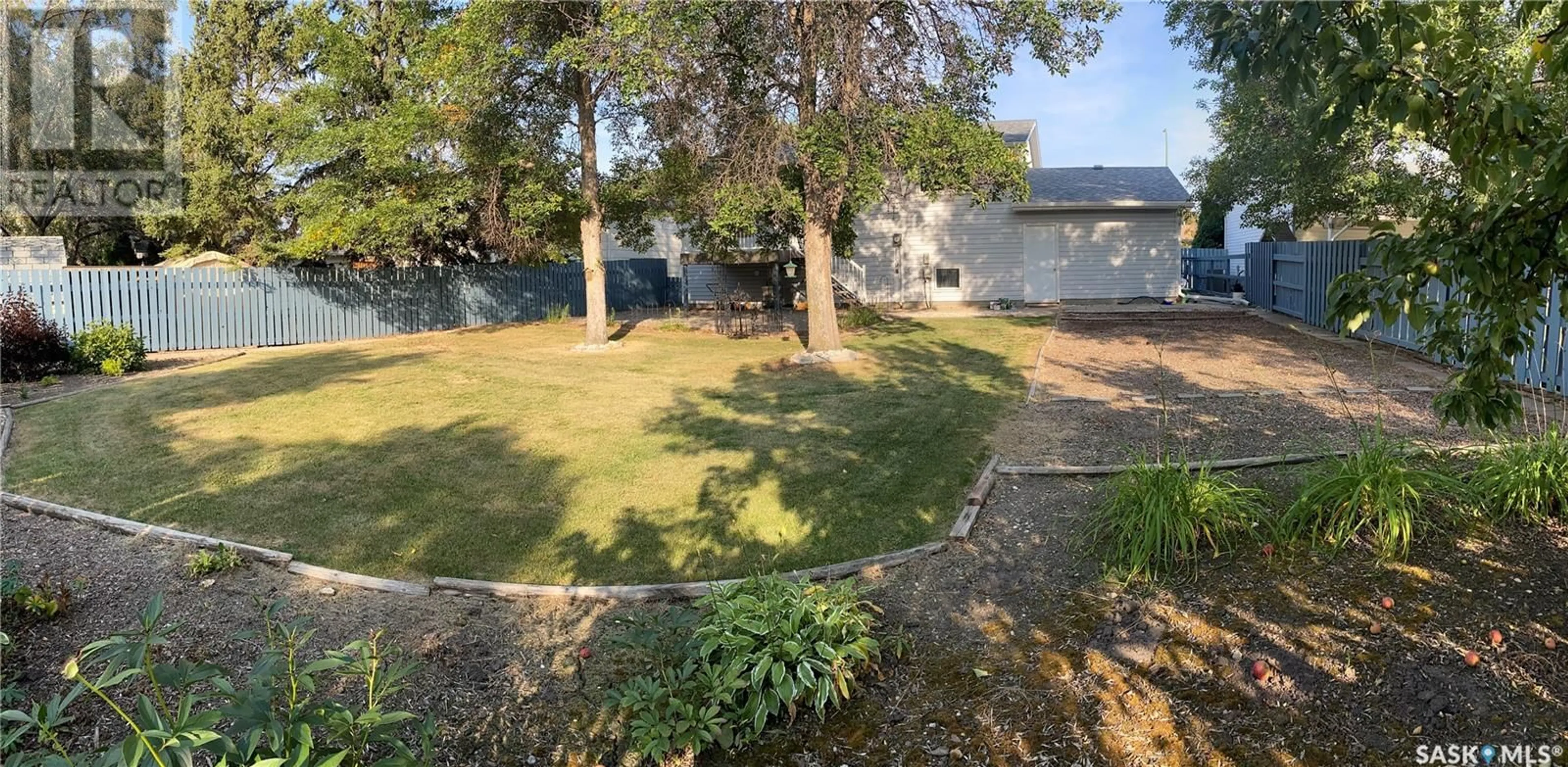 Frontside or backside of a home, the fenced backyard for 2115 100A STREET, Tisdale Saskatchewan S0E1T0