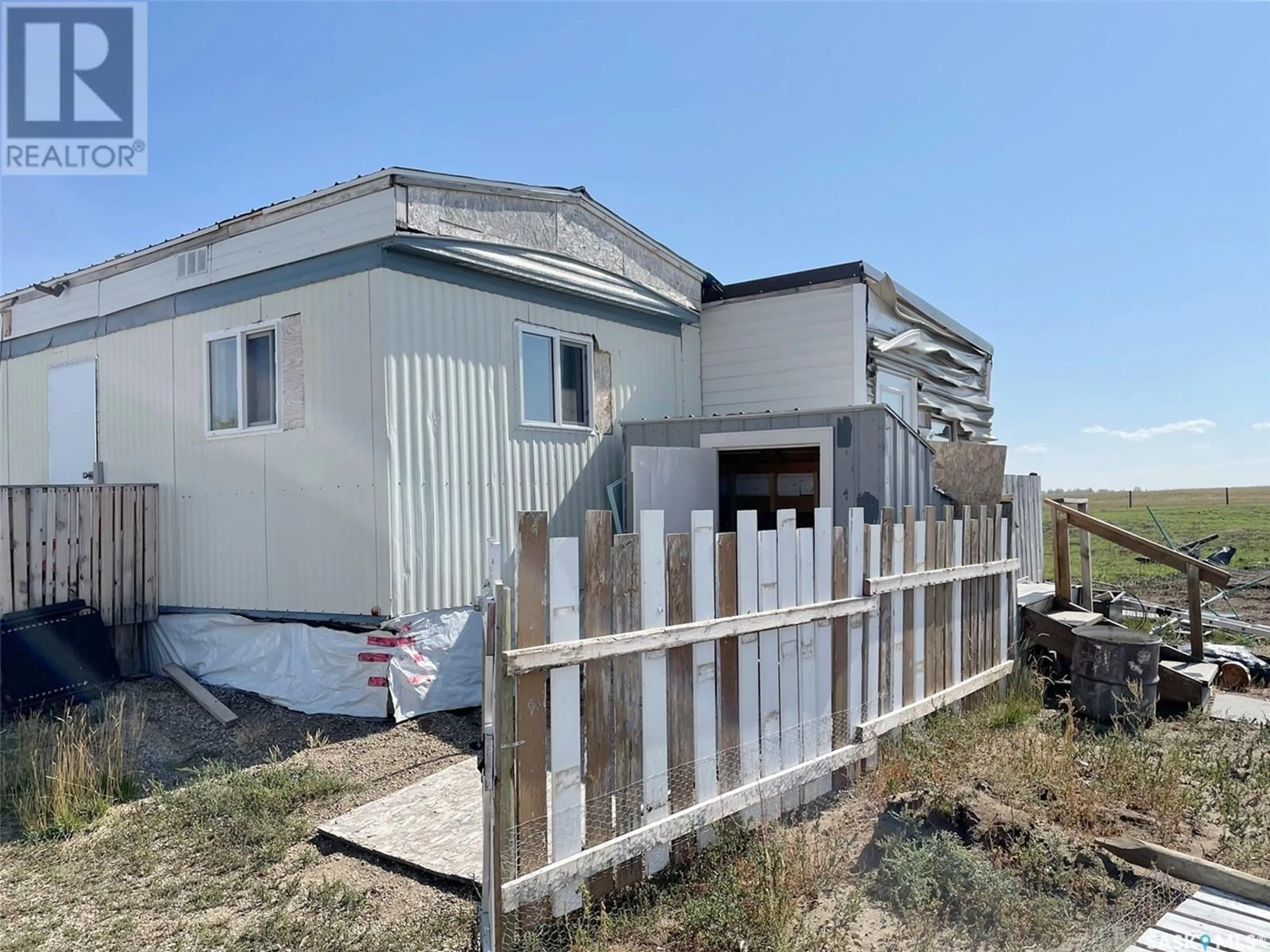 Frontside or backside of a home, the fenced backyard for Anderson Acreage, Lake Johnston Rm No. 102 Saskatchewan S0H3G0