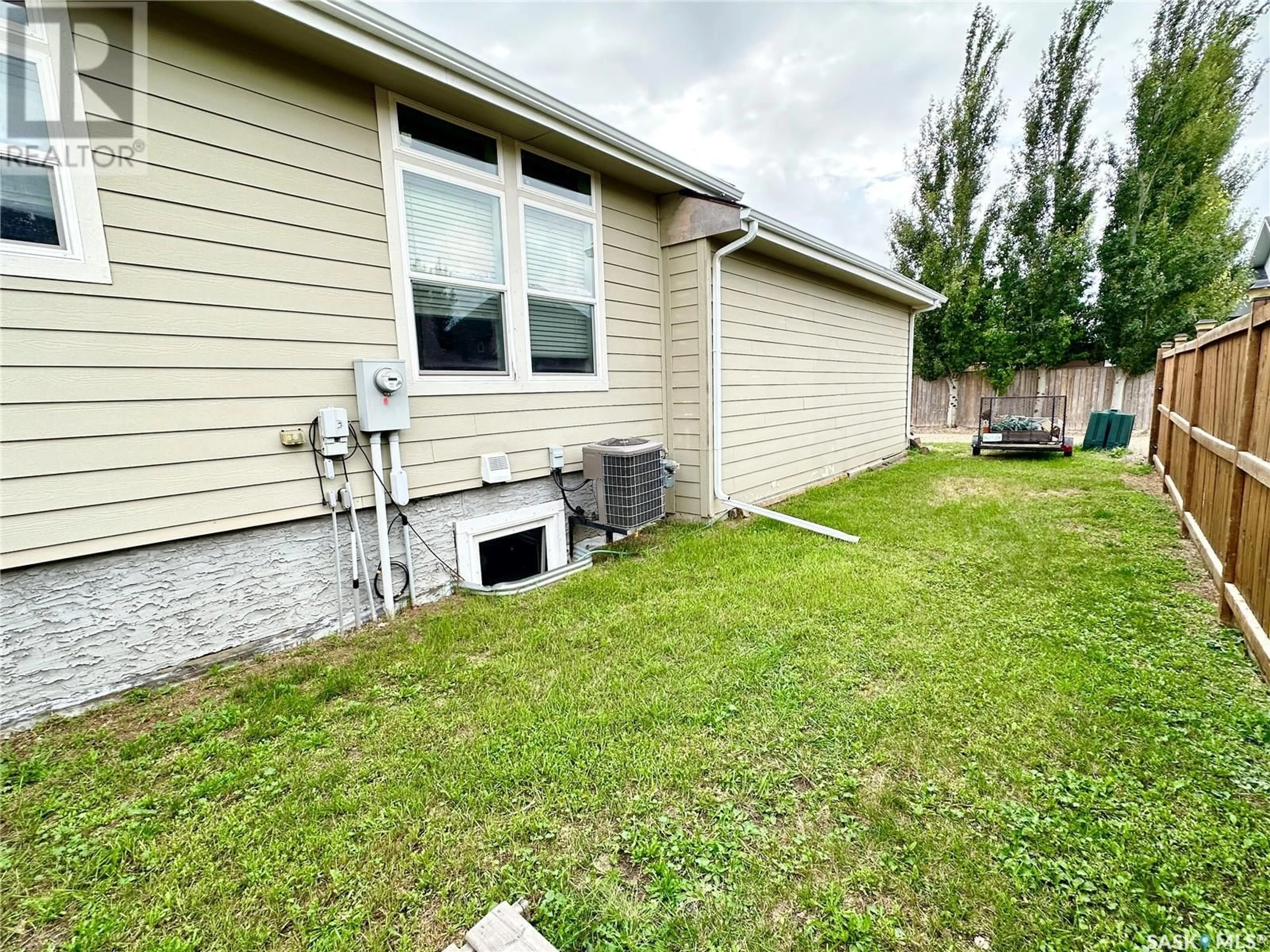 Frontside or backside of a home, the fenced backyard for 796 Johnston DRIVE, Weyburn Saskatchewan S4H3M5