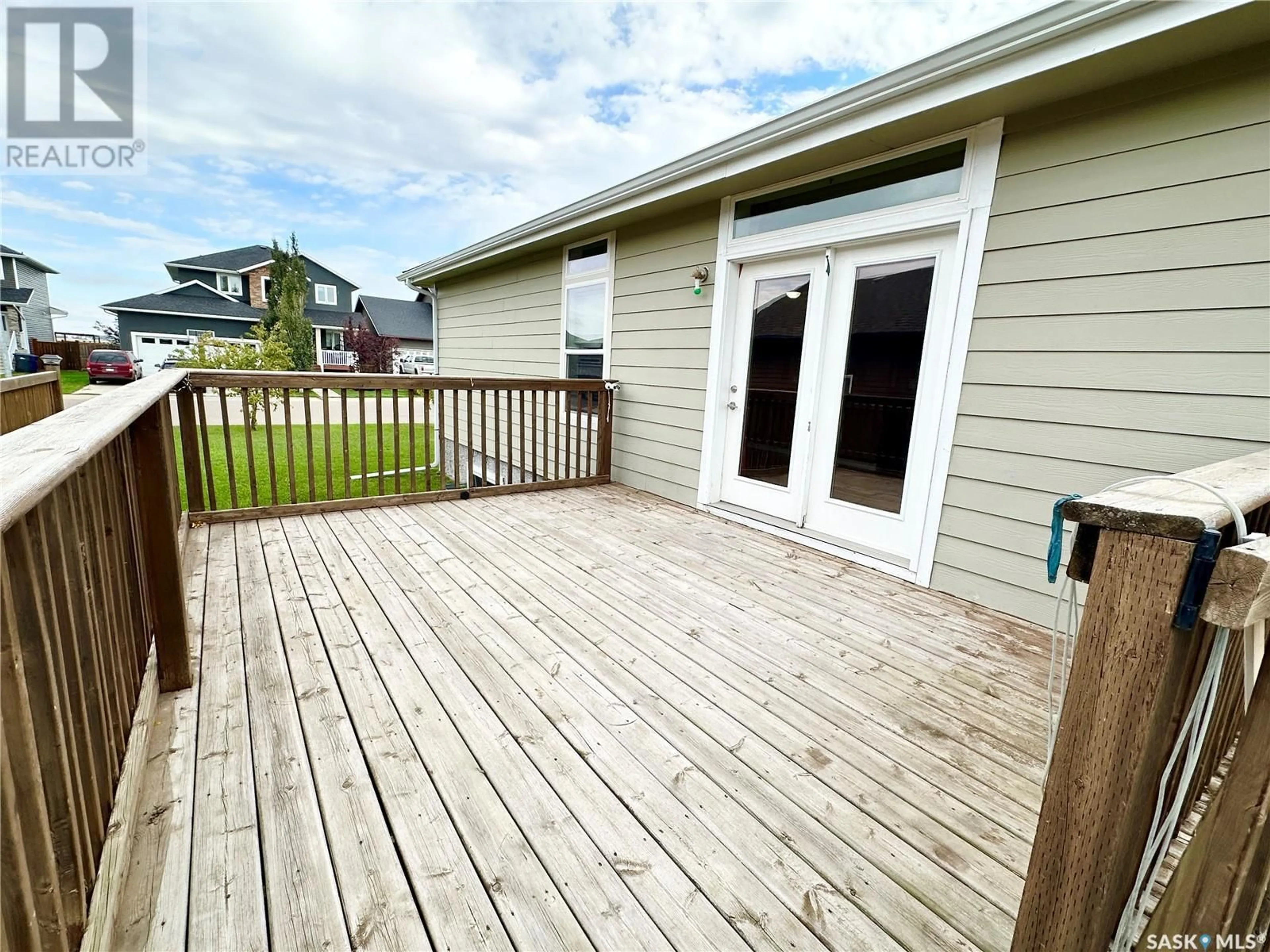 Frontside or backside of a home, the fenced backyard for 796 Johnston DRIVE, Weyburn Saskatchewan S4H3M5