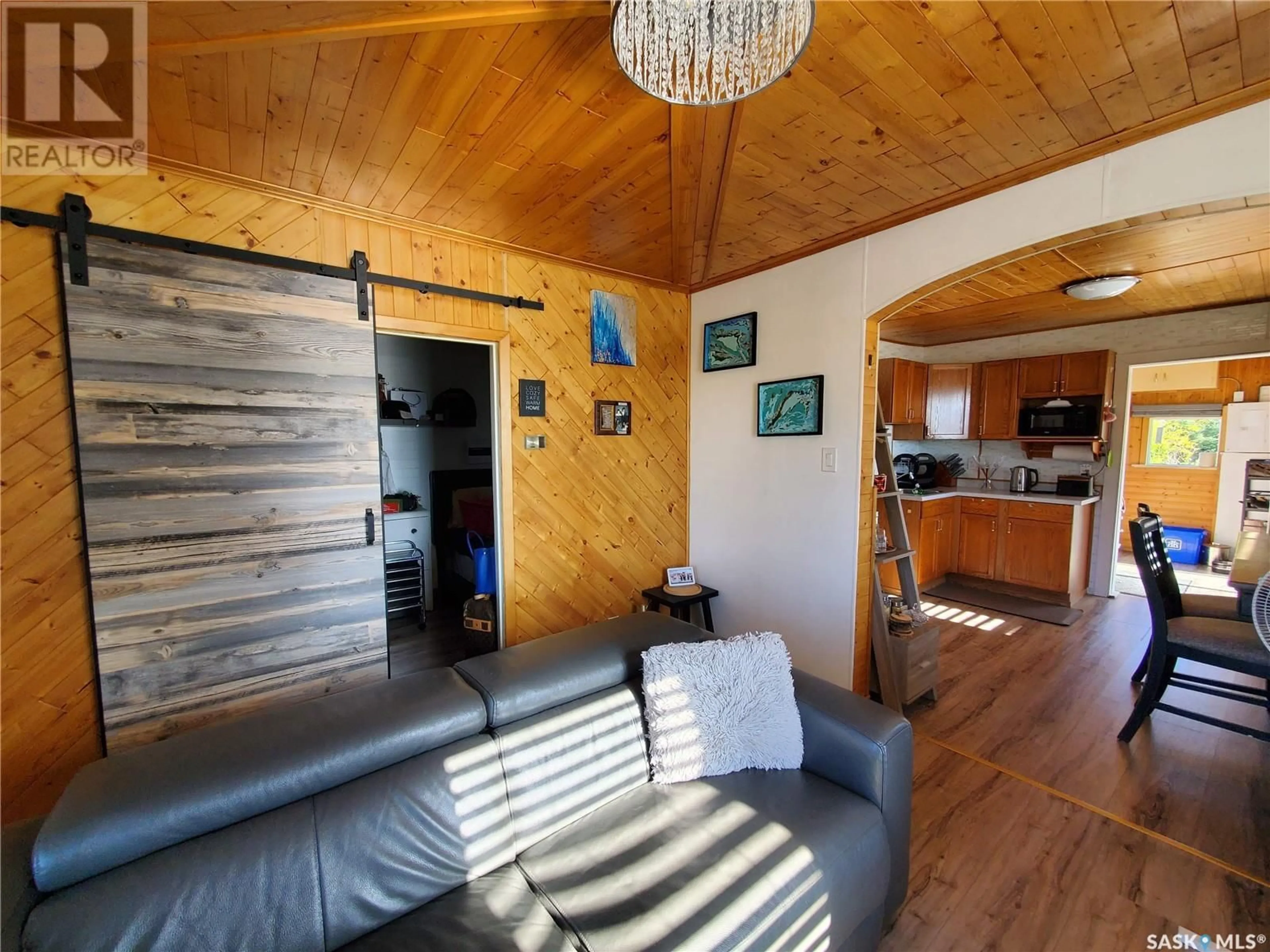 Living room with furniture, wood/laminate floor for 209 NYKOLAISHEN DRIVE, Kamsack Saskatchewan S0A1S0
