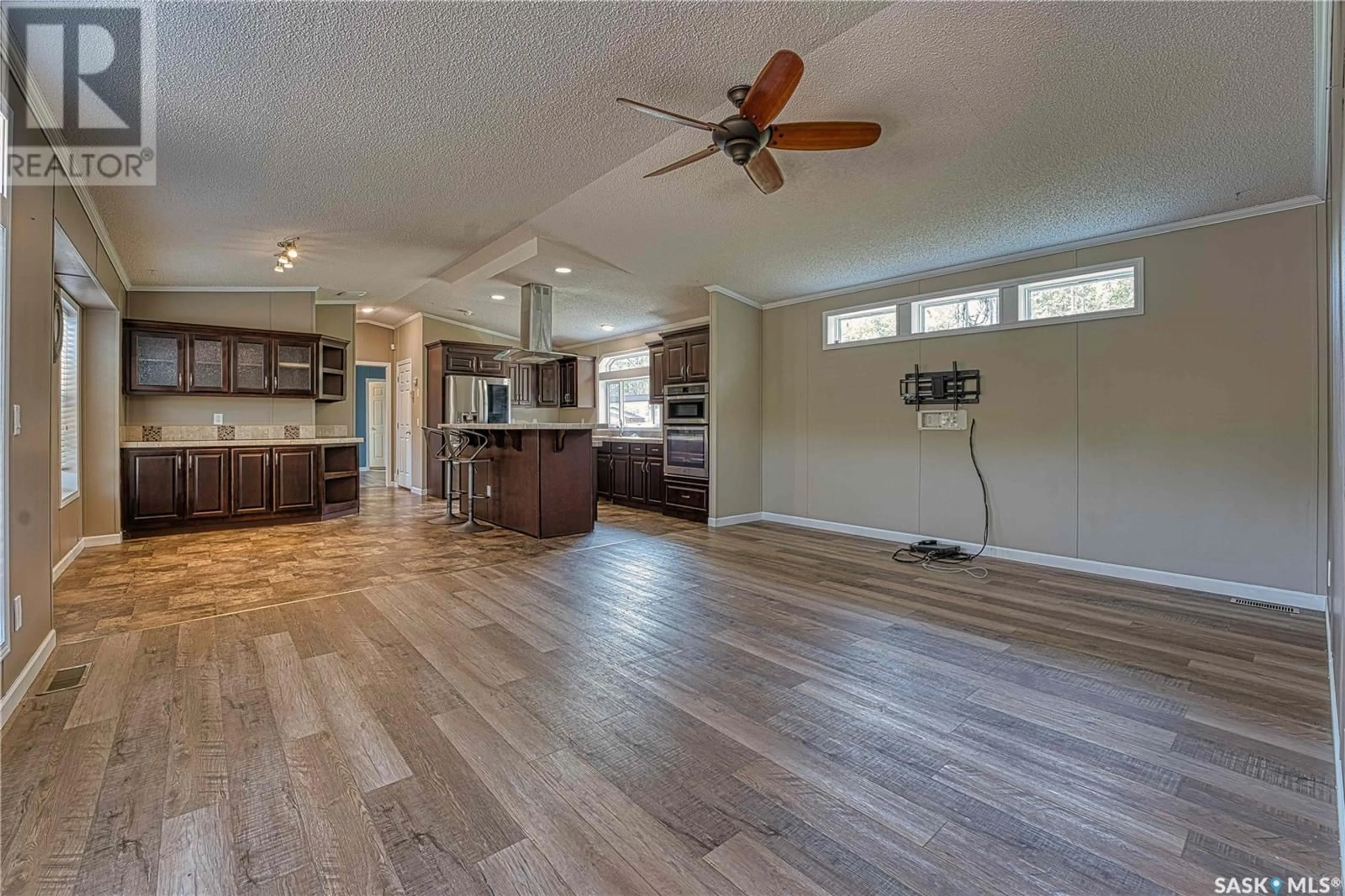 Open concept kitchen, wood/laminate floor for Hobby Farm - 61474 RR 3265, Pierceland Saskatchewan S0M2K0