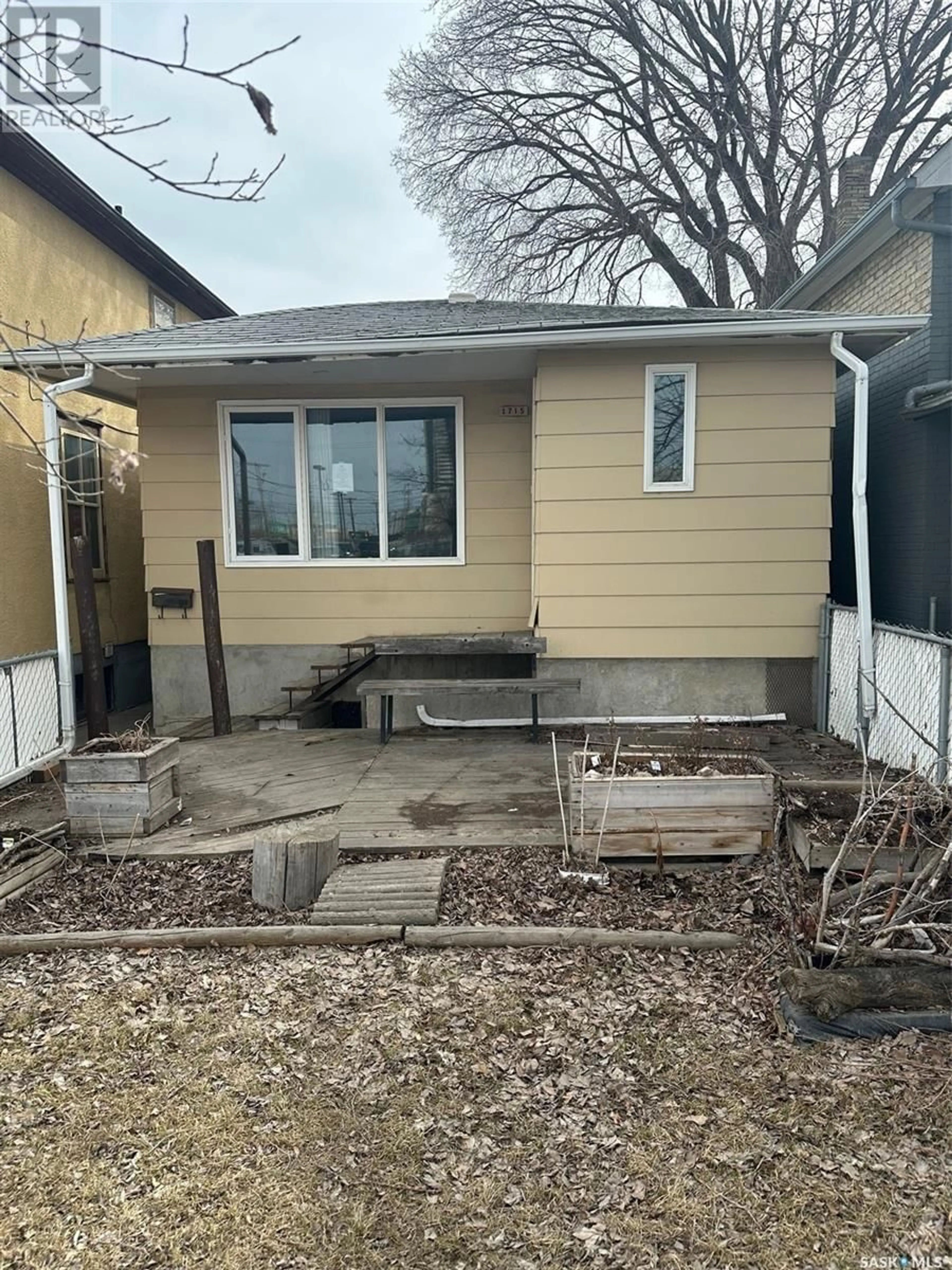 Frontside or backside of a home, the fenced backyard for 1715 St John STREET, Regina Saskatchewan S4P1R8