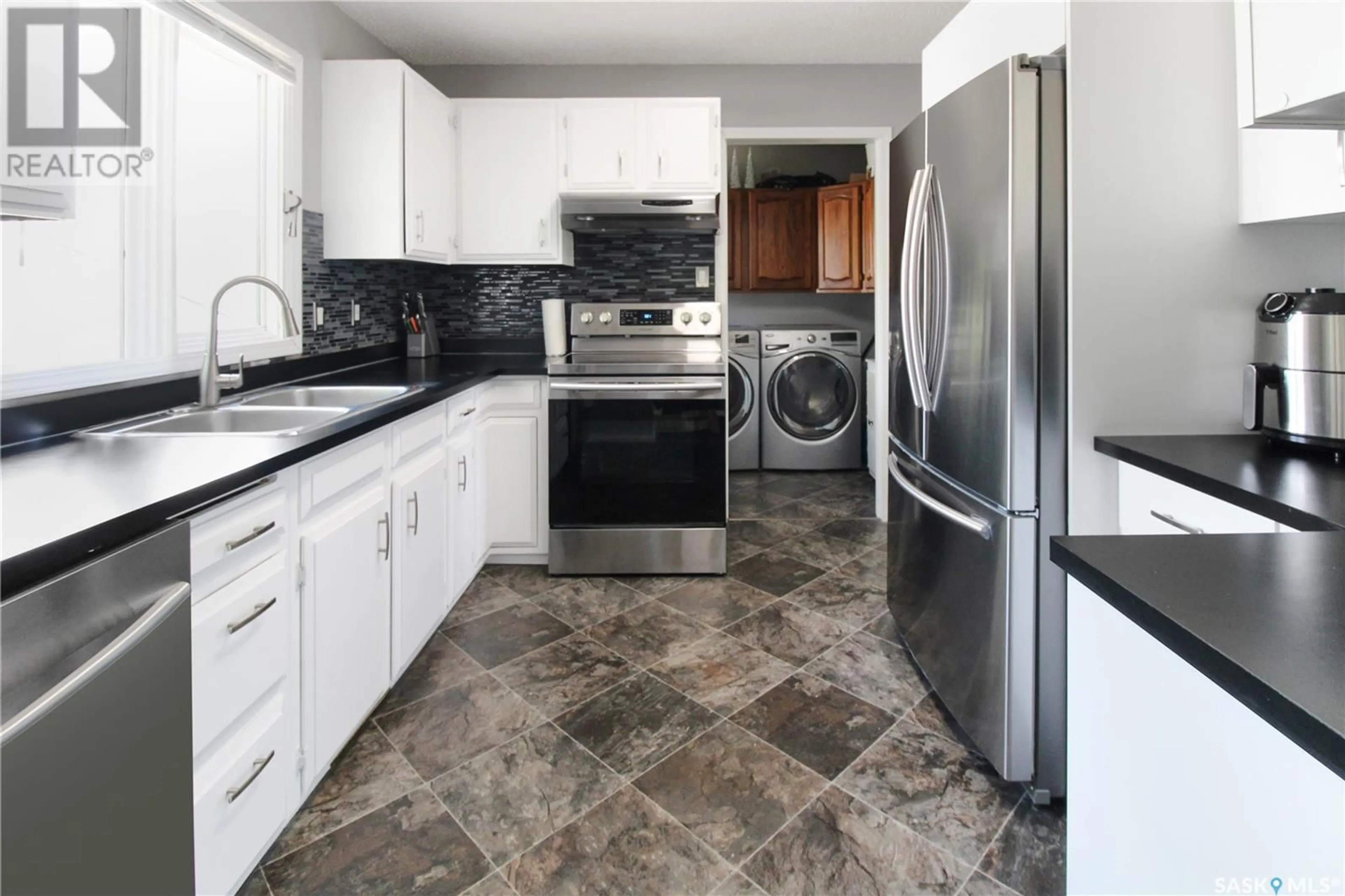 Kitchen with laundary machines, ceramic floors for 229 6th AVENUE NW, Swift Current Saskatchewan S9H0X7