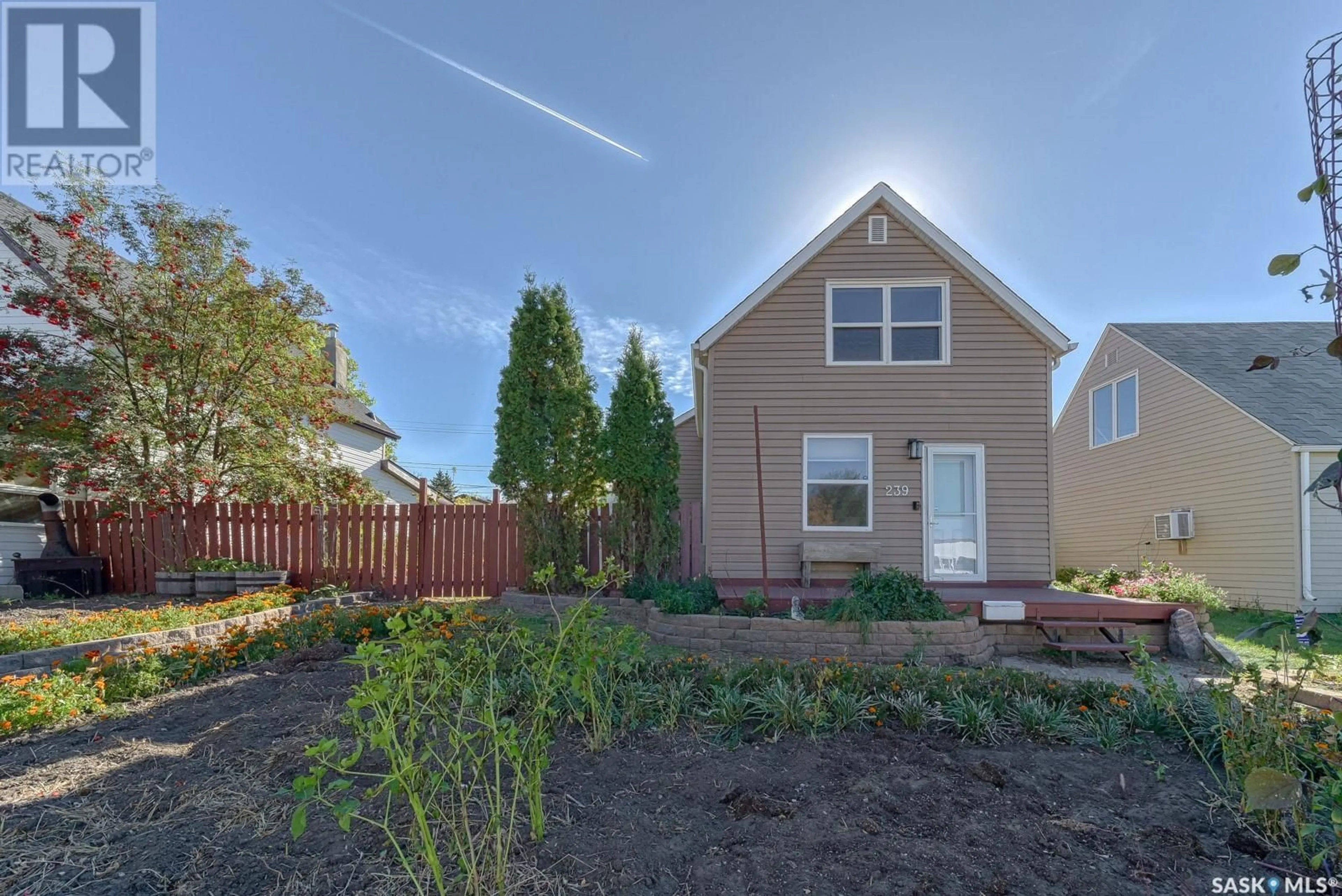 Frontside or backside of a home, the fenced backyard for 239 Home STREET W, Moose Jaw Saskatchewan S6H4X4