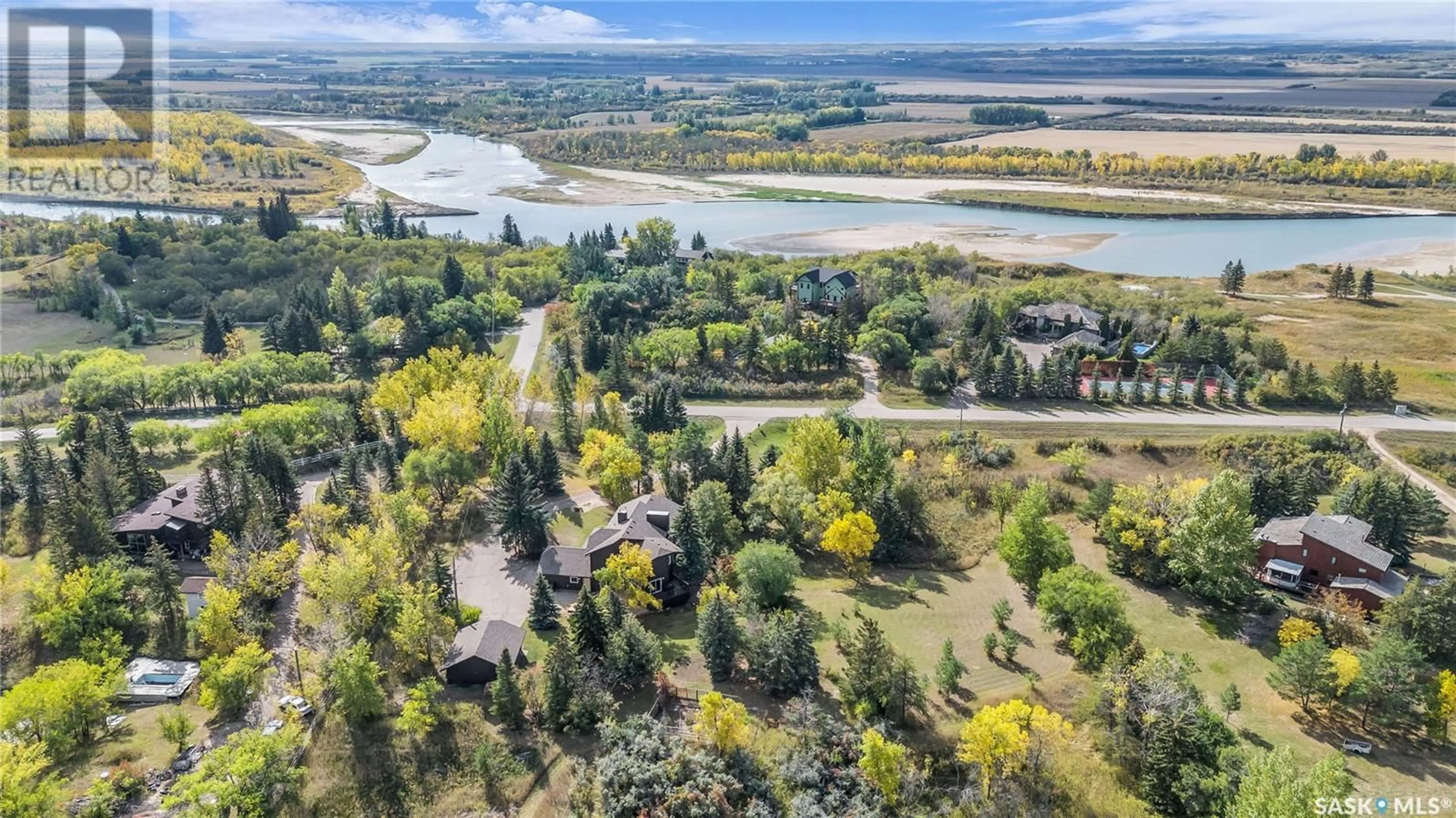 A pic from outside/outdoor area/front of a property/back of a property/a pic from drone, water/lake/river/ocean view for 25 Pony TRAIL, Riverside Estates Saskatchewan S7T1A2