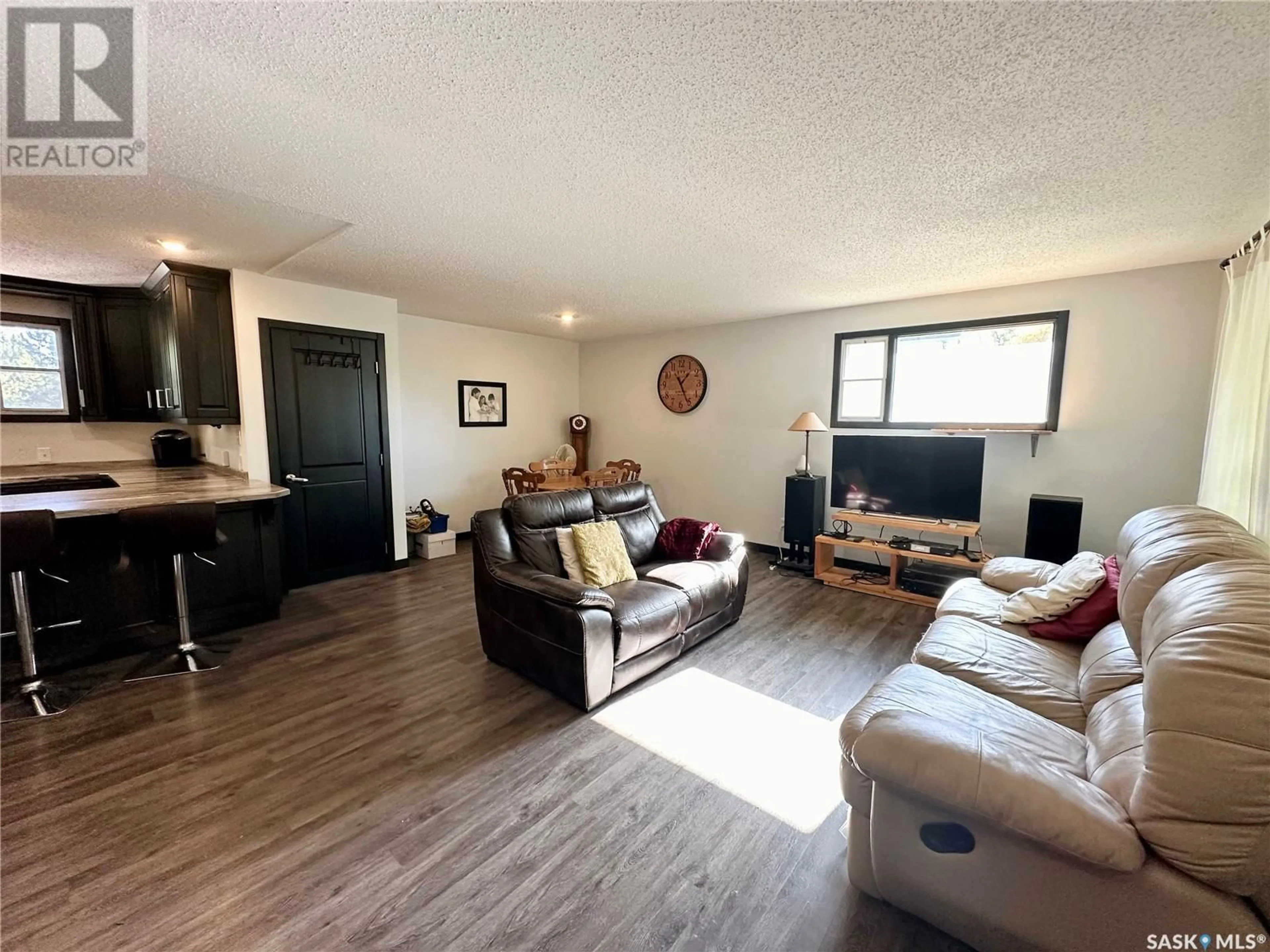 Living room with furniture, wood/laminate floor for 1512 106TH STREET, North Battleford Saskatchewan S9A1X8