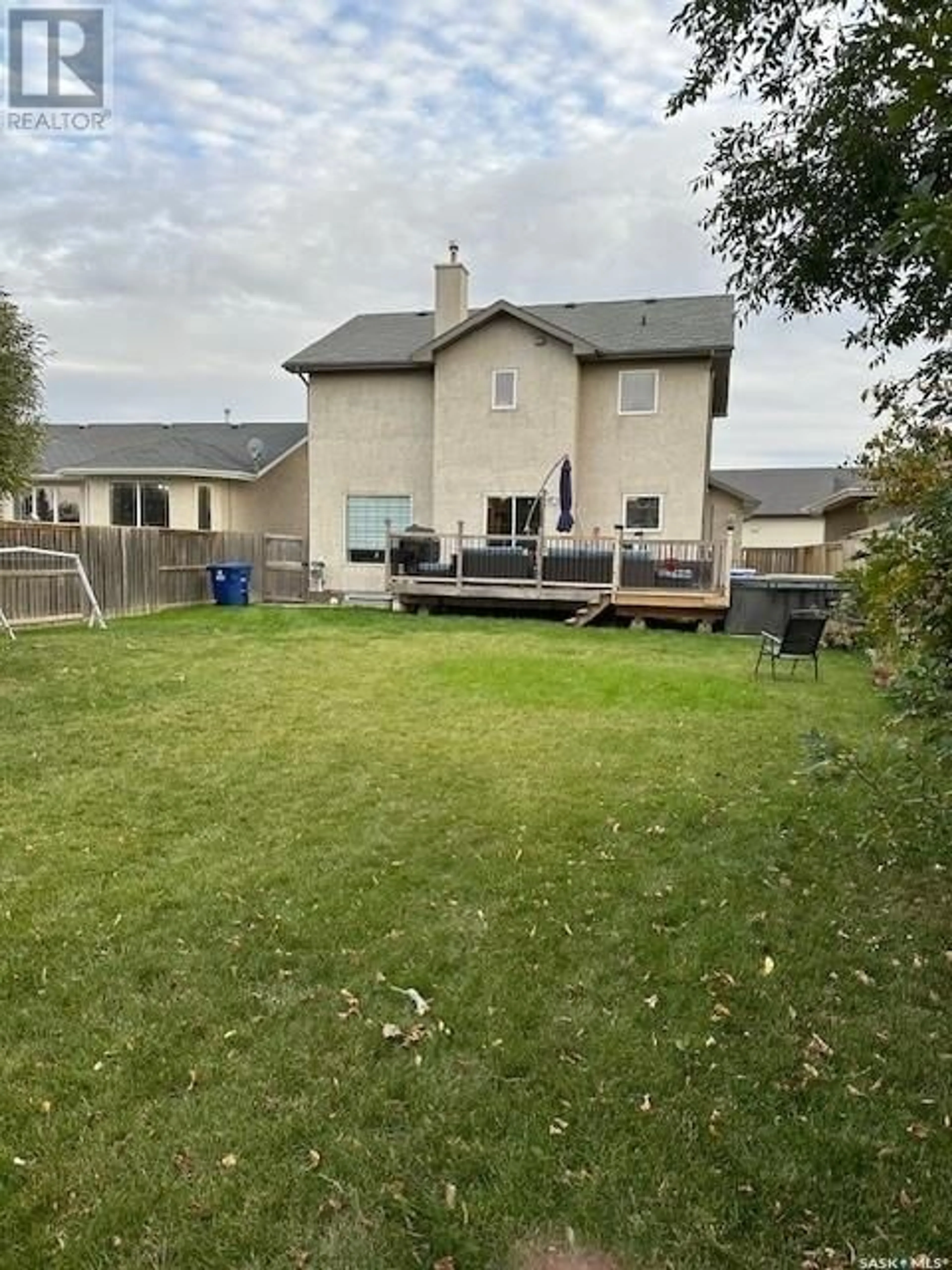 Frontside or backside of a home, the fenced backyard for 110 Maguire COURT, Saskatoon Saskatchewan S7W1A2