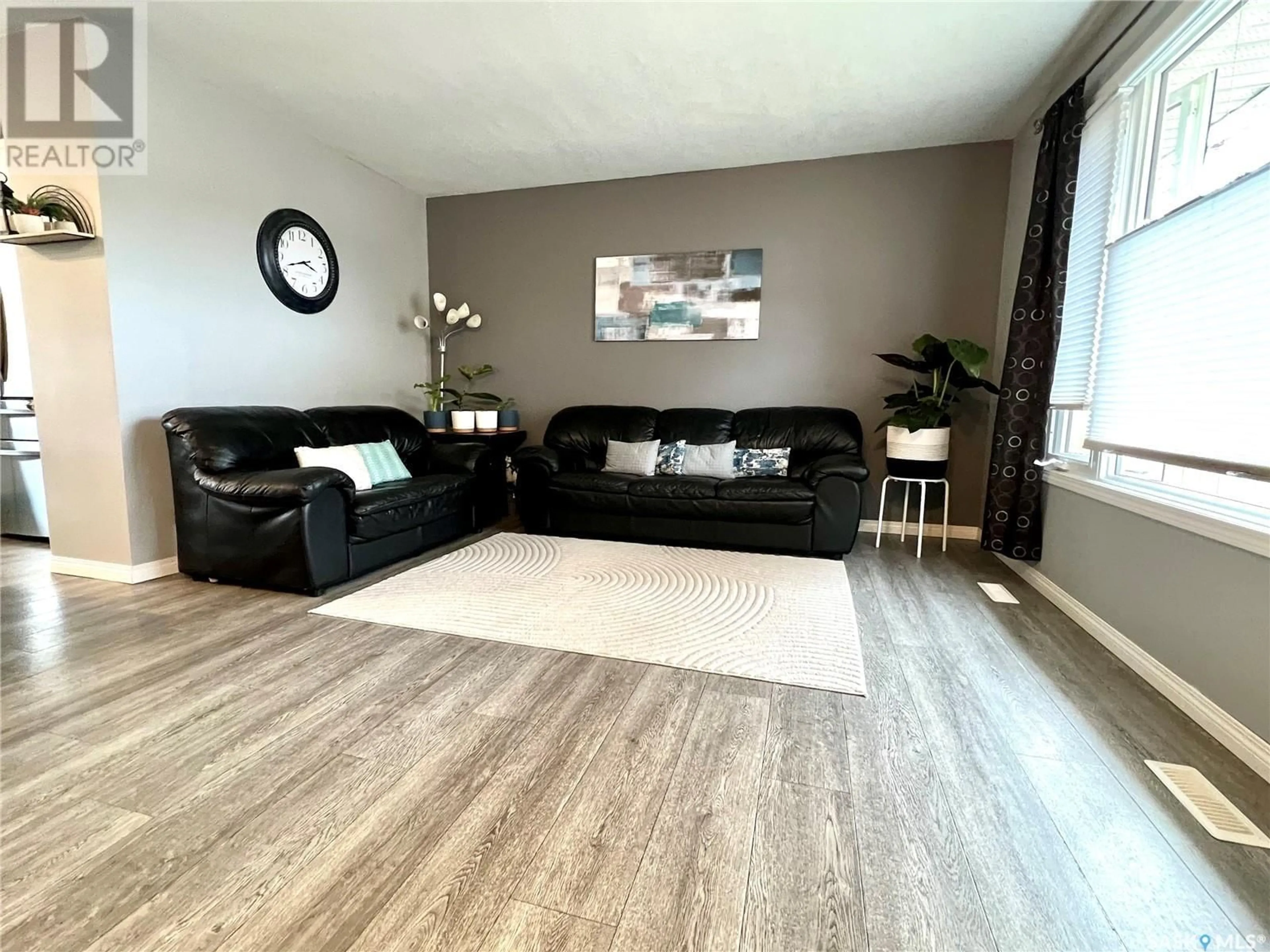 Living room with furniture, wood/laminate floor for 621 CENTRAL AVENUE, Swift Current Saskatchewan S9H3G7