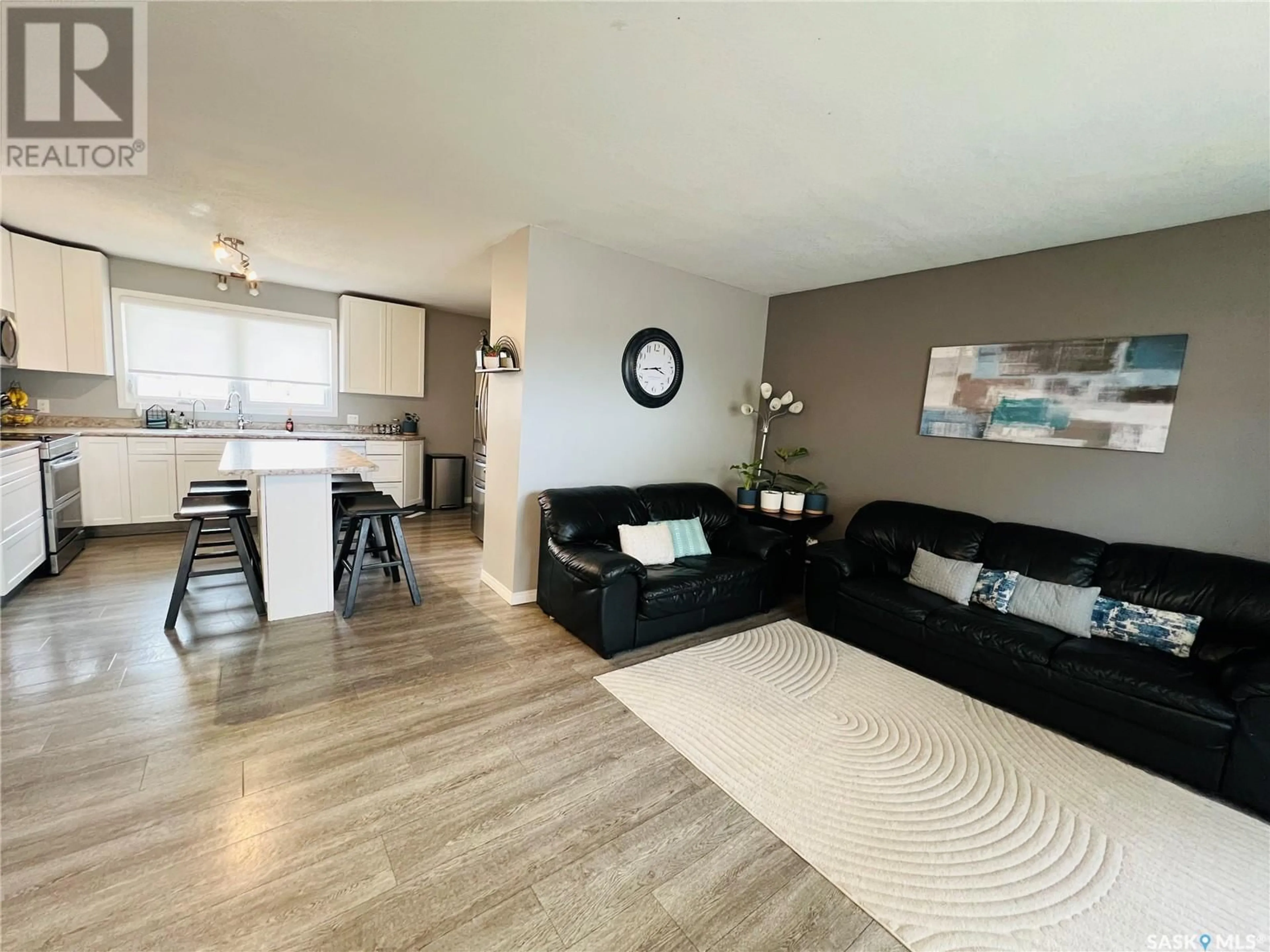 Living room with furniture, wood/laminate floor for 621 CENTRAL AVENUE, Swift Current Saskatchewan S9H3G7