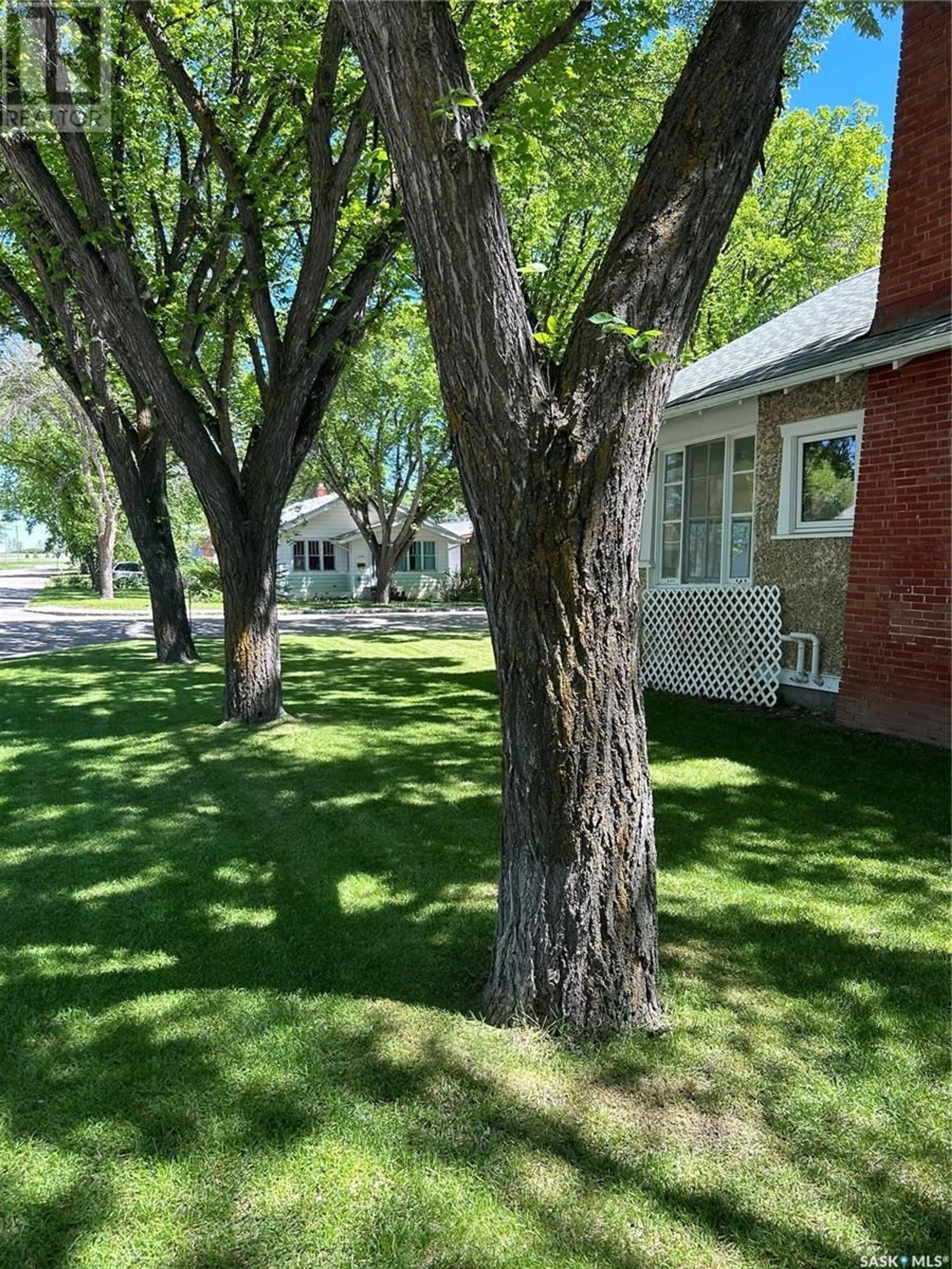 A pic from exterior of the house or condo, the fenced backyard for 695 3rd STREET E, Shaunavon Saskatchewan S0N2M0