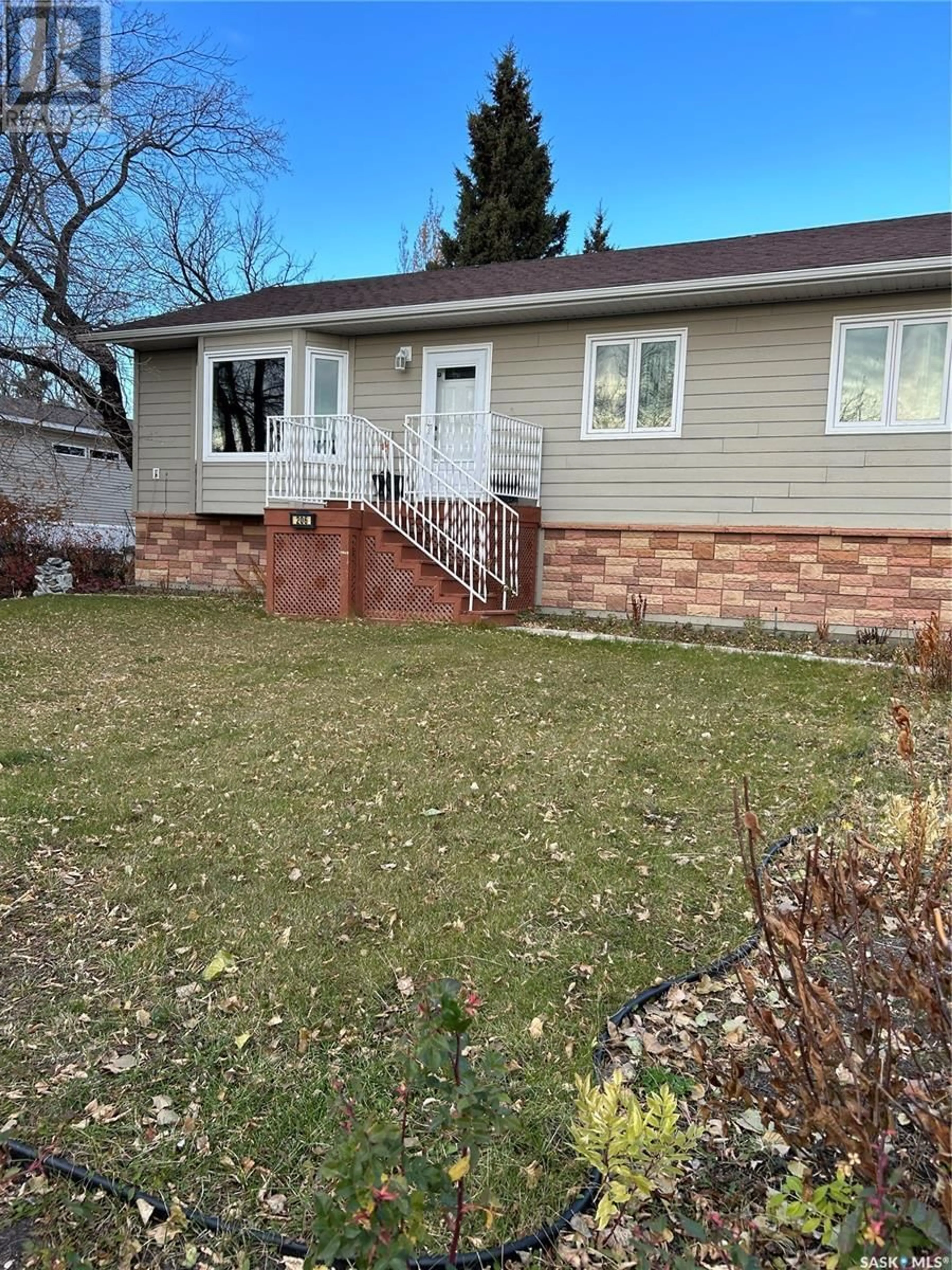 Frontside or backside of a home, the fenced backyard for 206 4th AVENUE E, Kelvington Saskatchewan S0A1W0