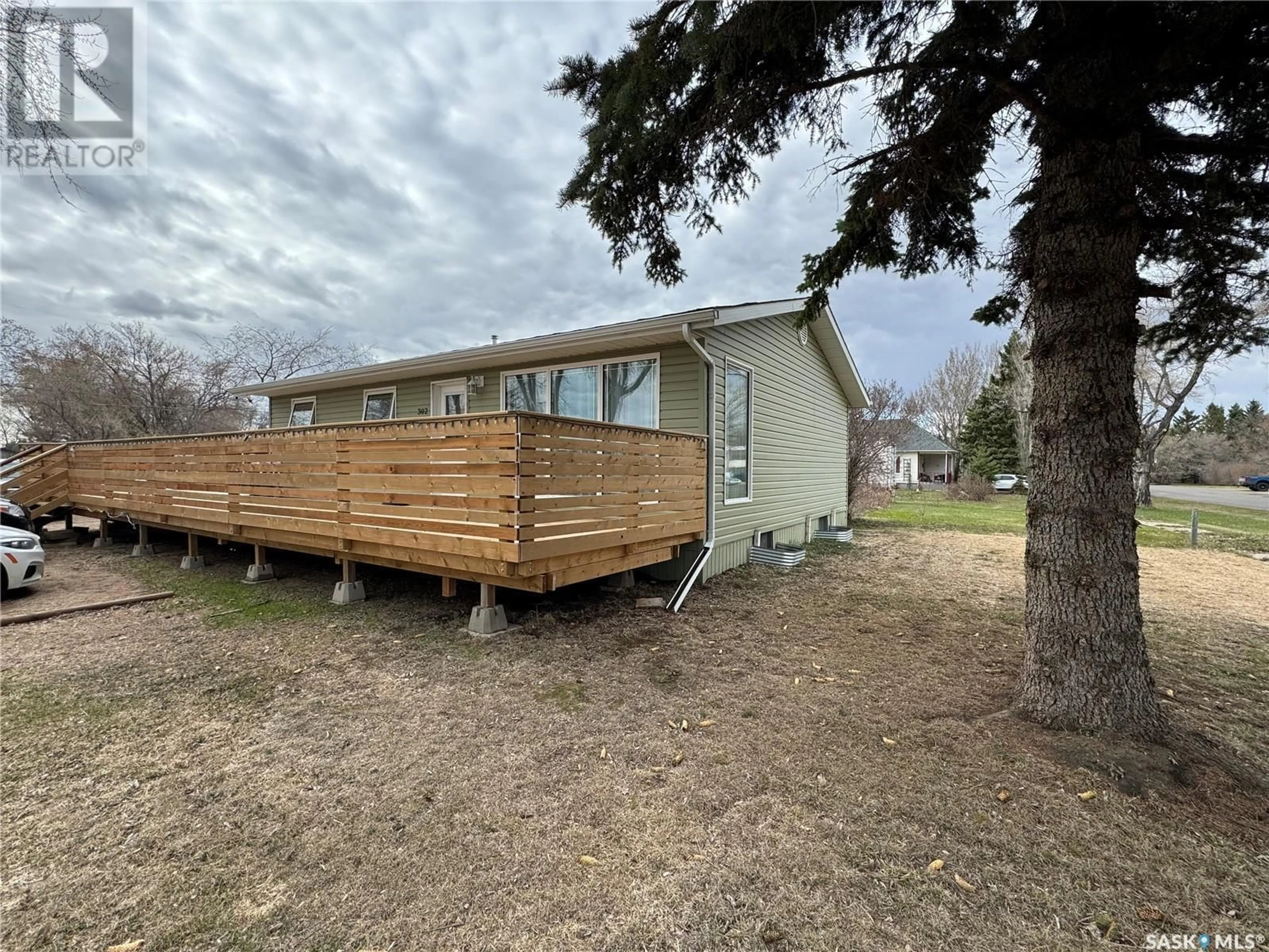 Frontside or backside of a home, the fenced backyard for 302 2nd AVENUE E, Buchanan Saskatchewan S0A0J0