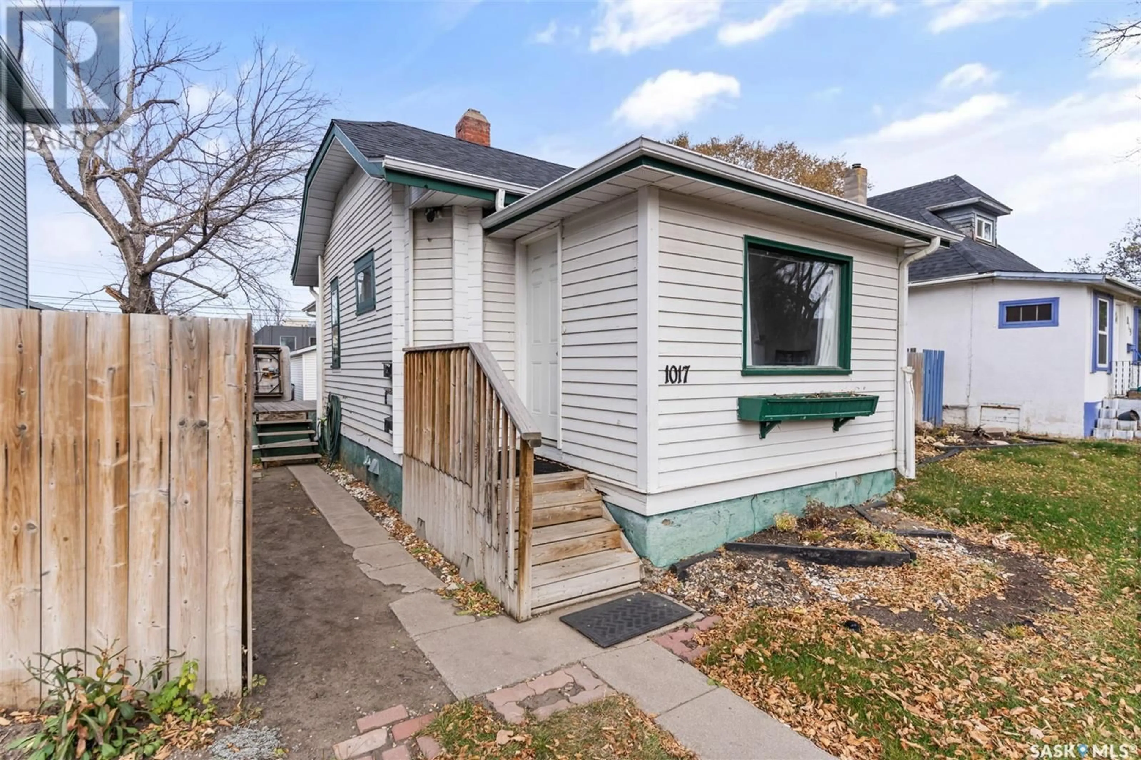 Frontside or backside of a home, the fenced backyard for 1017 7th STREET E, Saskatoon Saskatchewan S7H0Y7