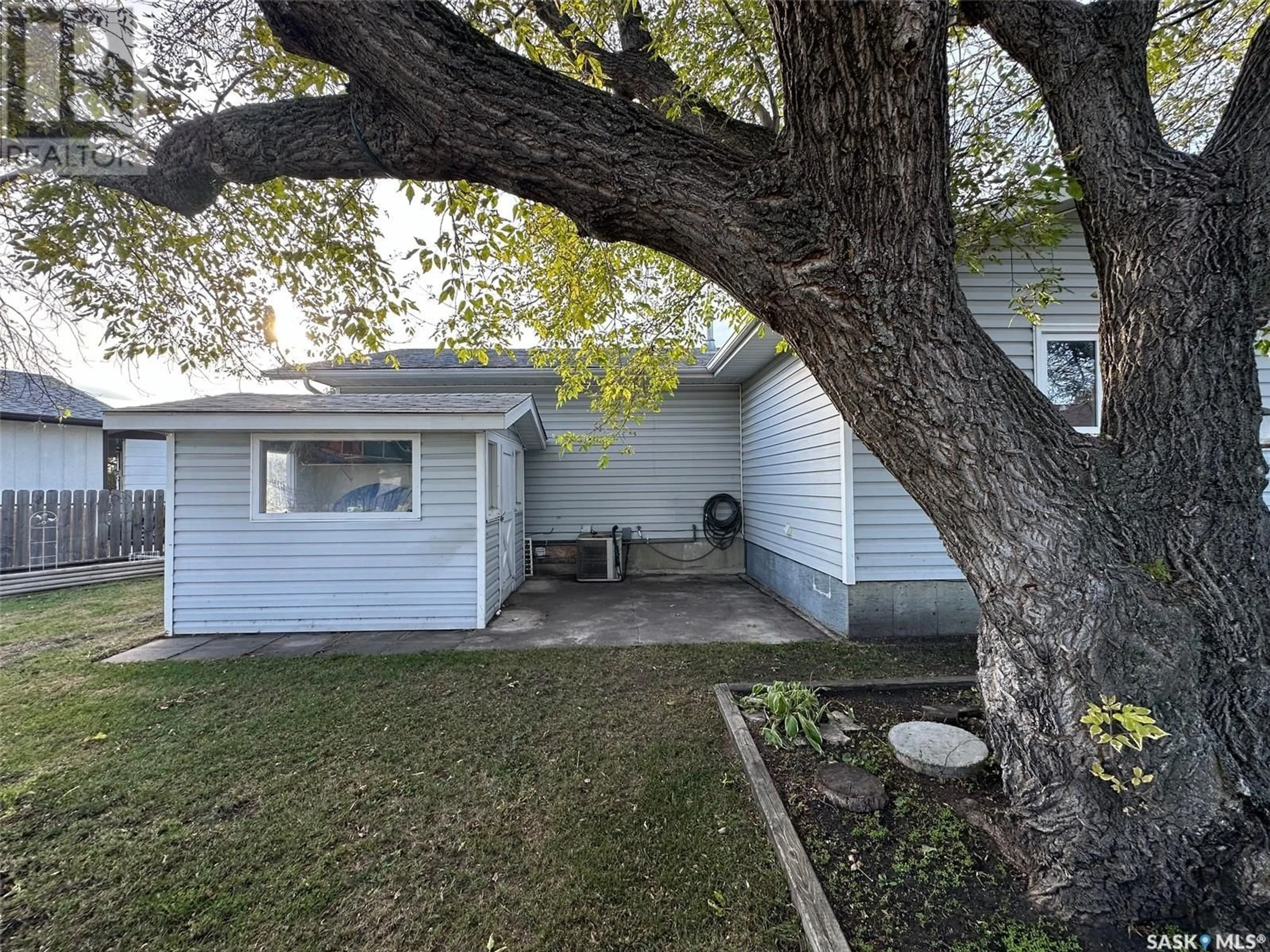 Frontside or backside of a home, the fenced backyard for 737 Willow PLACE, Hudson Bay Saskatchewan S0E0Y0