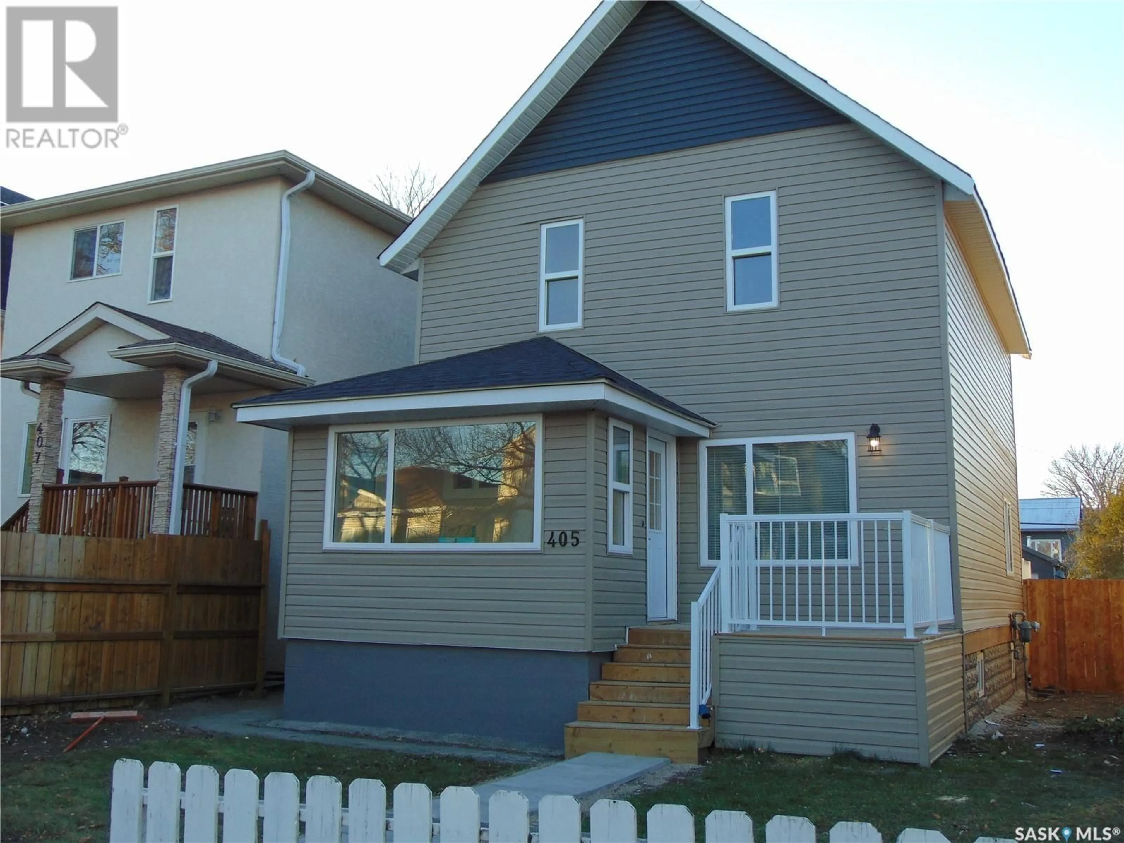 Frontside or backside of a home, the fenced backyard for 405 D AVENUE S, Saskatoon Saskatchewan S7M1R3