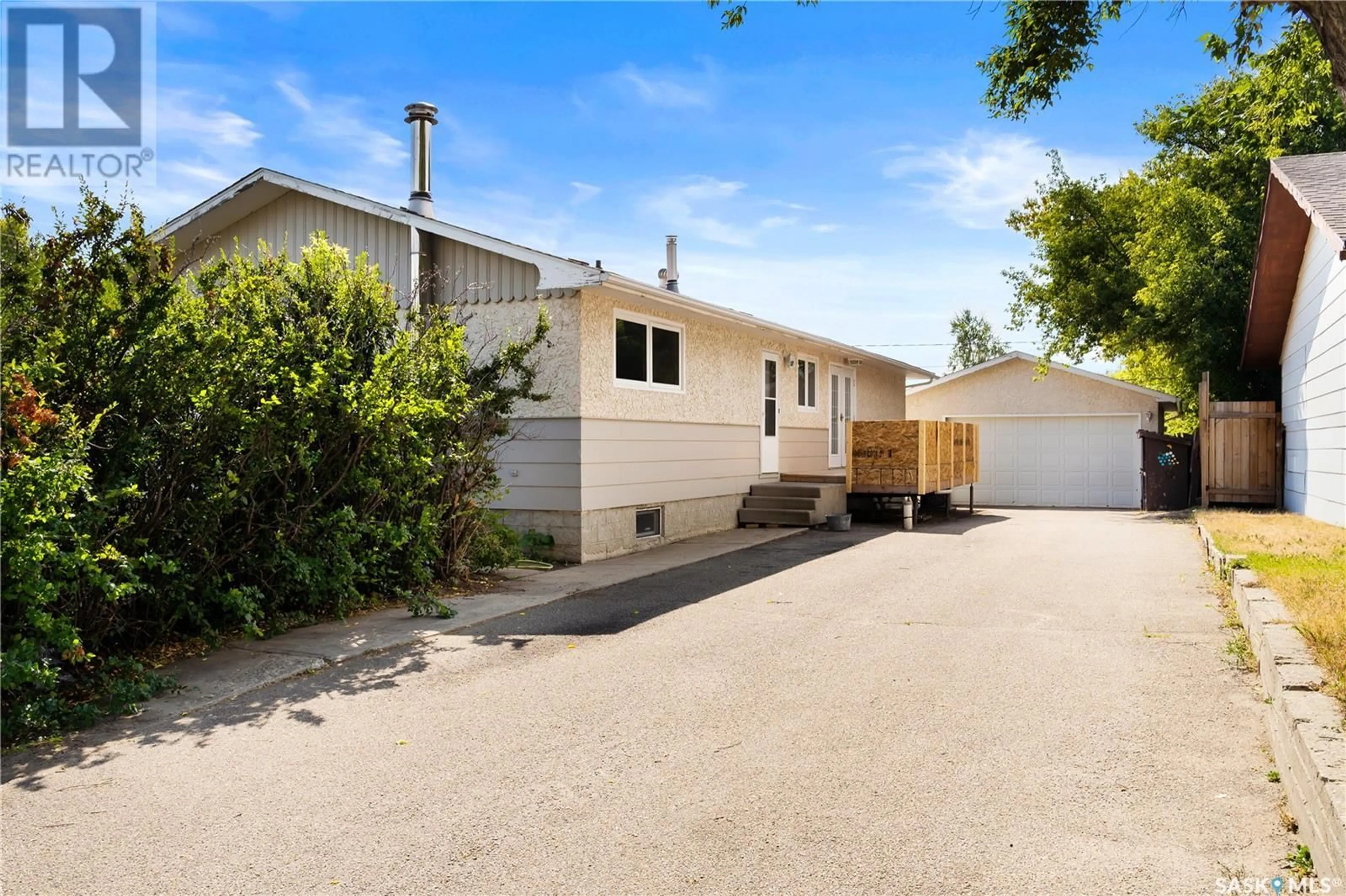 Frontside or backside of a home, the fenced backyard for 202 7th STREET, Pilot Butte Saskatchewan S0G3Z0