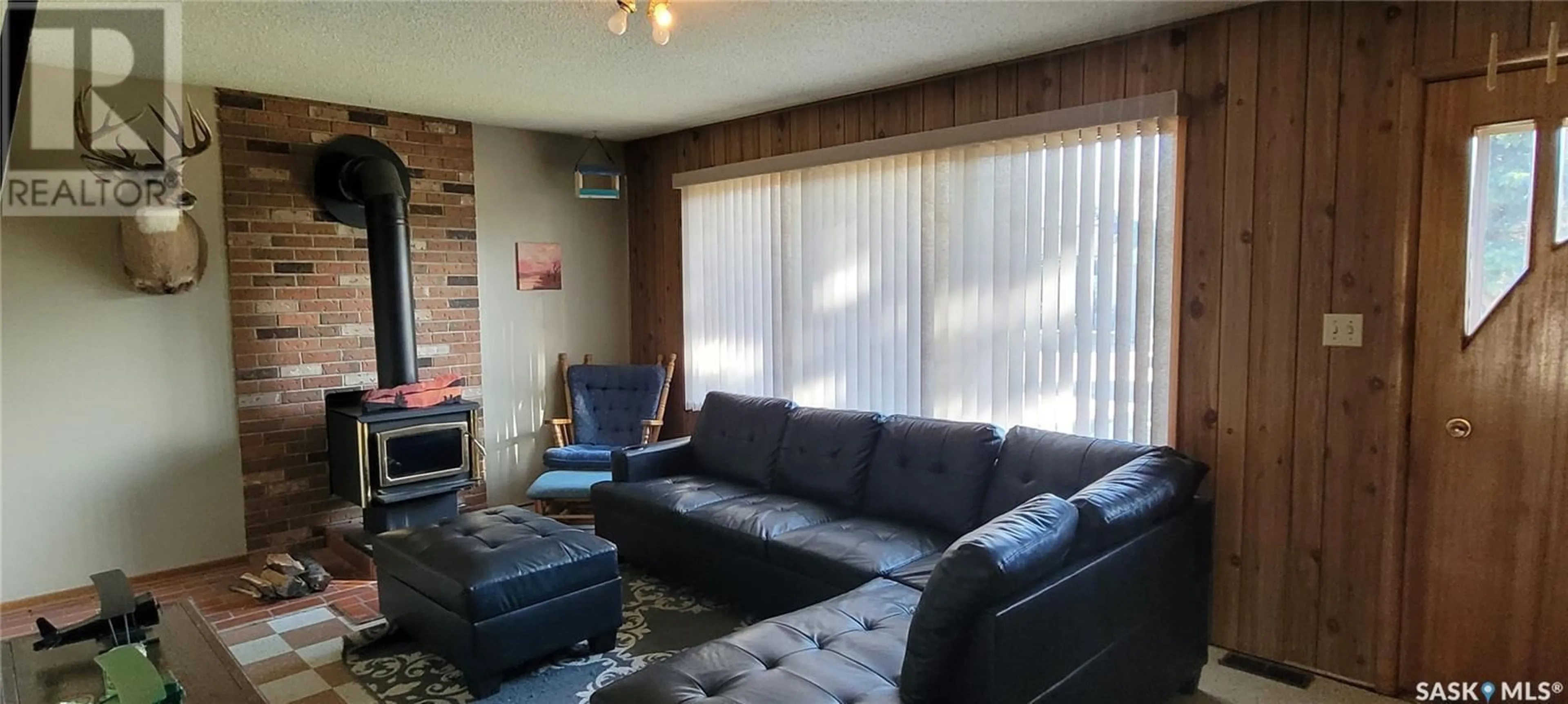 Living room with furniture, wood/laminate floor for 311 5TH AVENUE, Loon Lake Saskatchewan S0M1L0