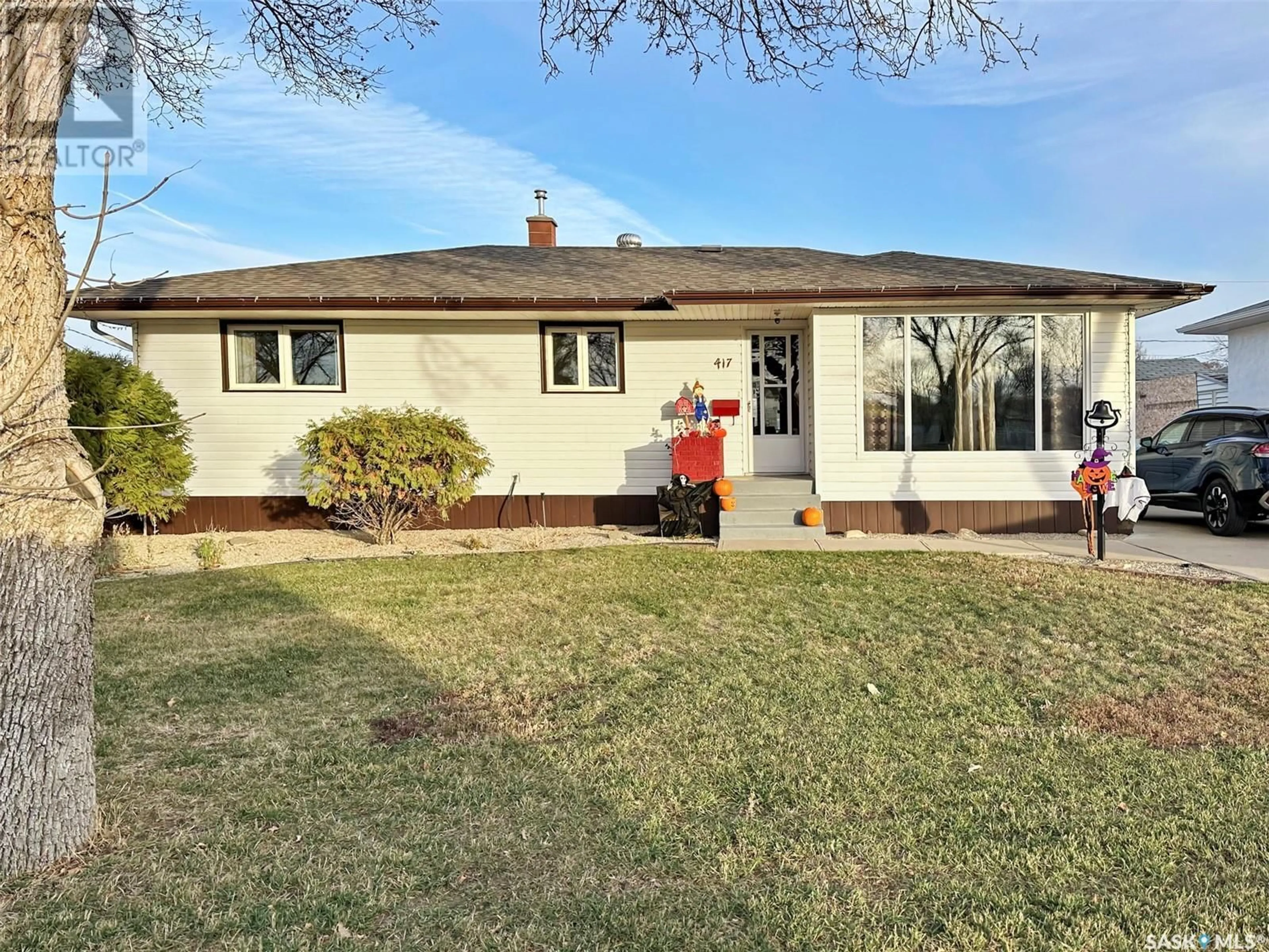 Frontside or backside of a home, the fenced backyard for 417 Central AVENUE S, Swift Current Saskatchewan S9H3G5