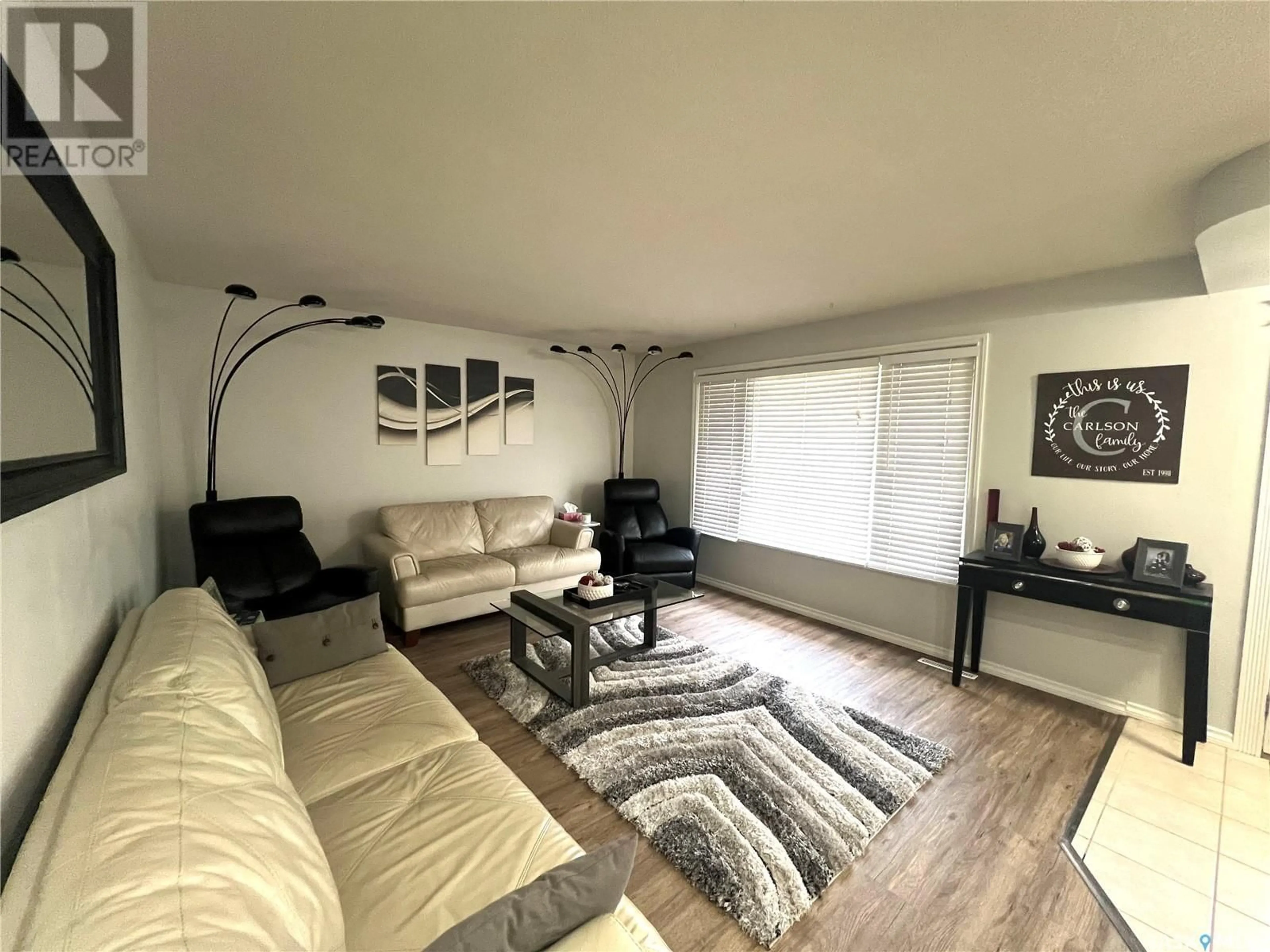 Living room with furniture, wood/laminate floor for 160 LORNE STREET, Swift Current Saskatchewan S9H0J5