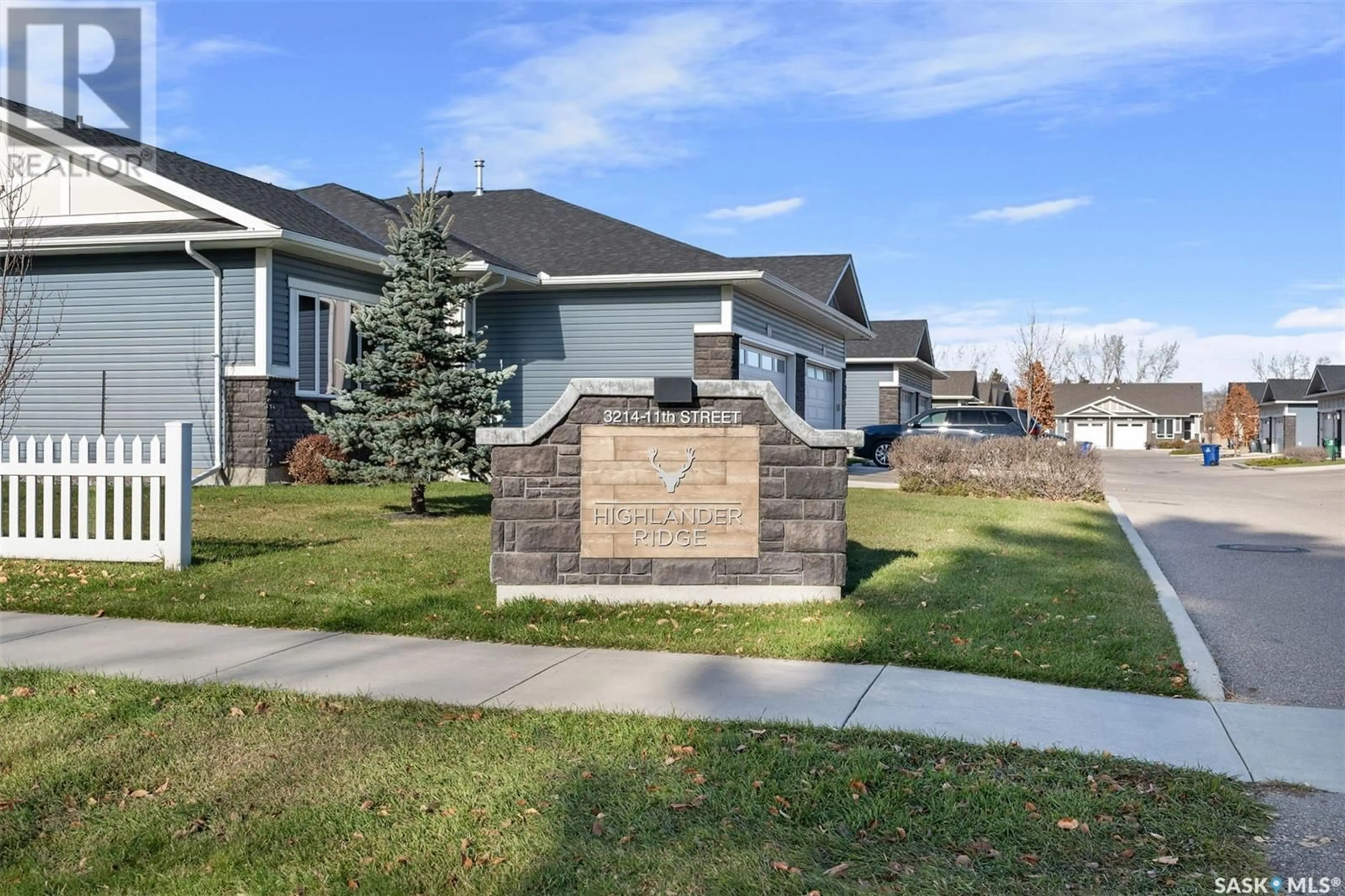 Frontside or backside of a home, the fenced backyard for 7 3214 11th STREET W, Saskatoon Saskatchewan S7M5G3