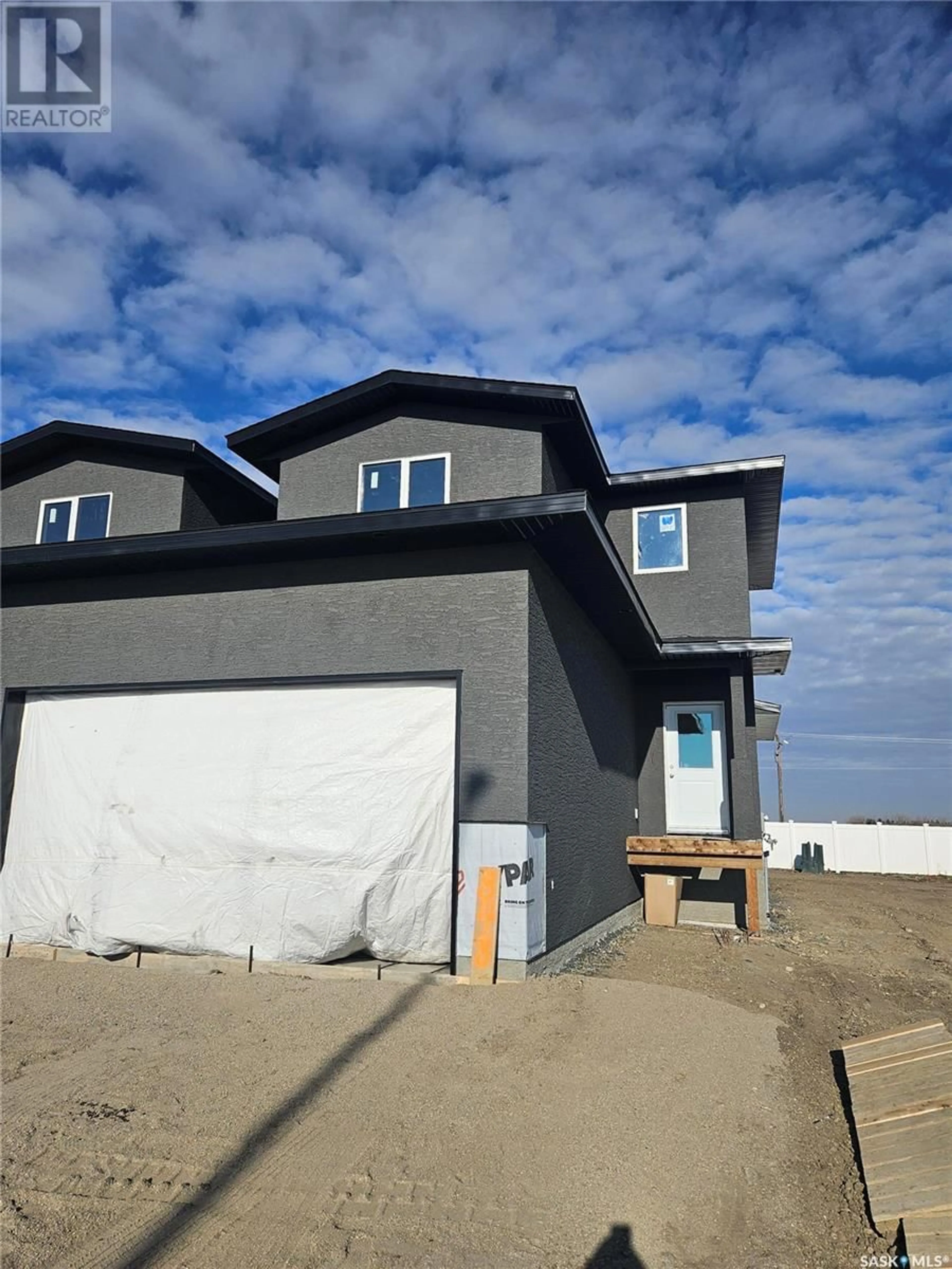 Home with vinyl exterior material, street for 848 DELAET BAY, Warman Saskatchewan S0K0A1