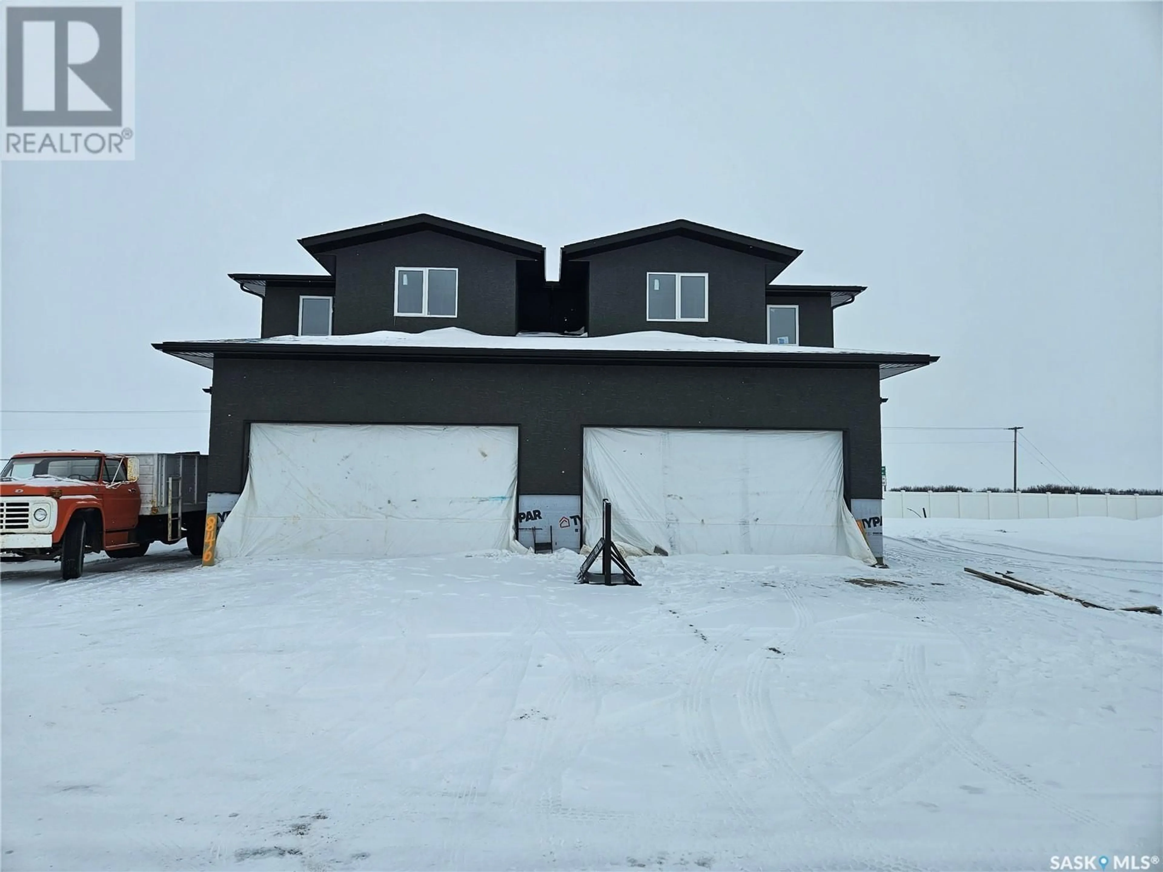 A pic from outside/outdoor area/front of a property/back of a property/a pic from drone, unknown for 848 DELAET BAY, Warman Saskatchewan S0K0A1