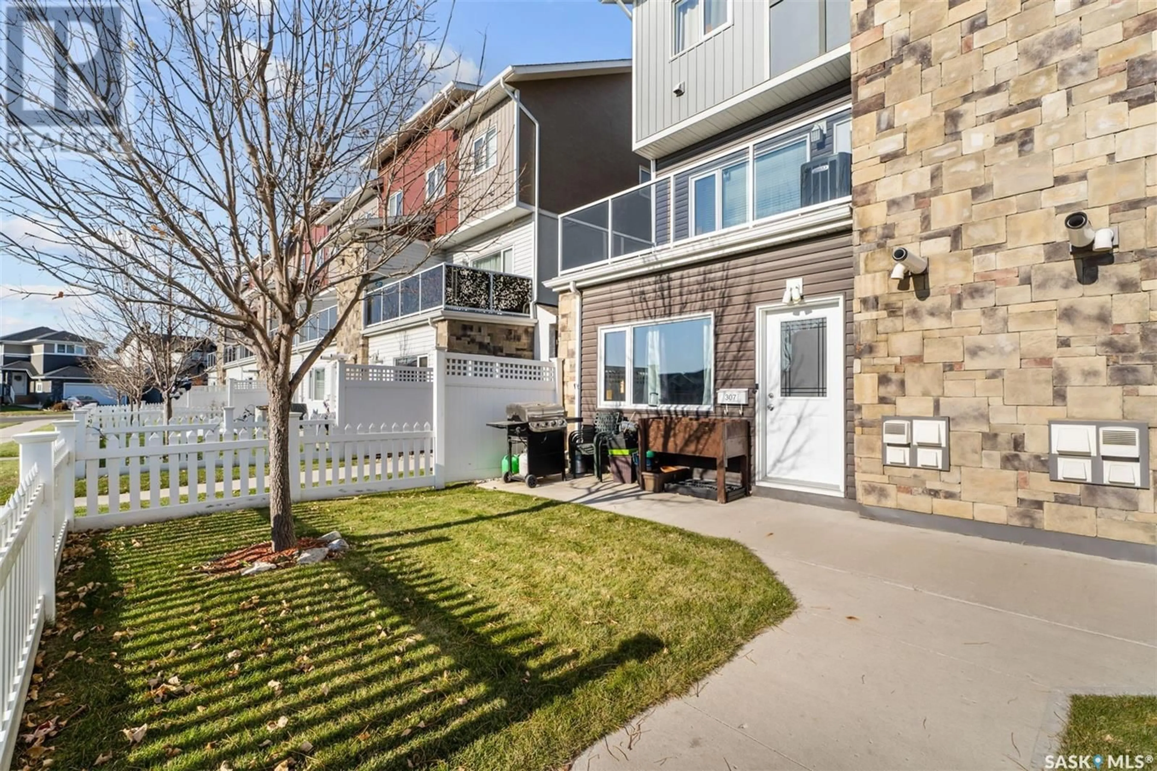 A pic from exterior of the house or condo, the fenced backyard for 307 225 Hassard CLOSE, Saskatoon Saskatchewan S7L2W8