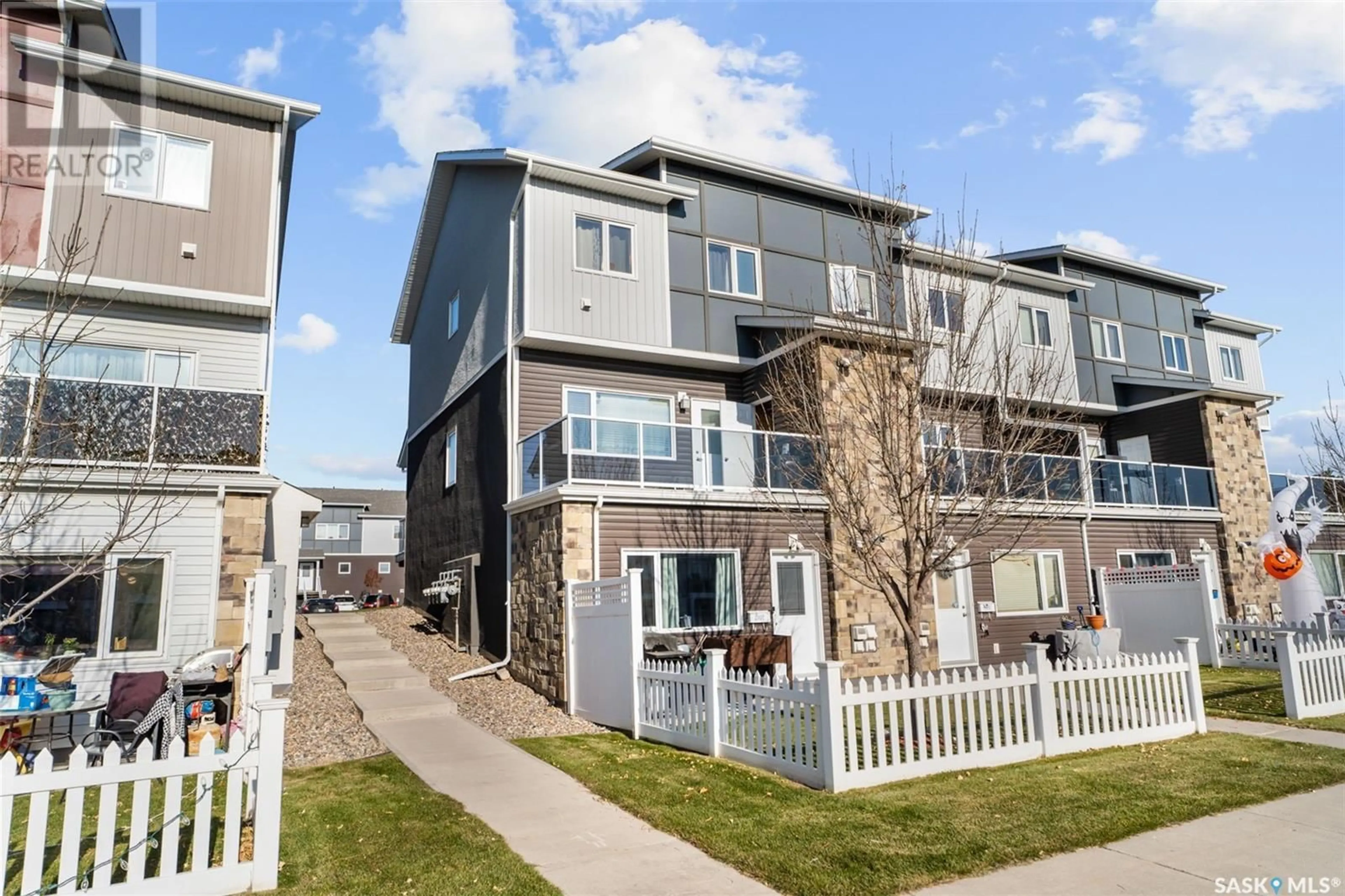 A pic from exterior of the house or condo, the fenced backyard for 307 225 Hassard CLOSE, Saskatoon Saskatchewan S7L2W8