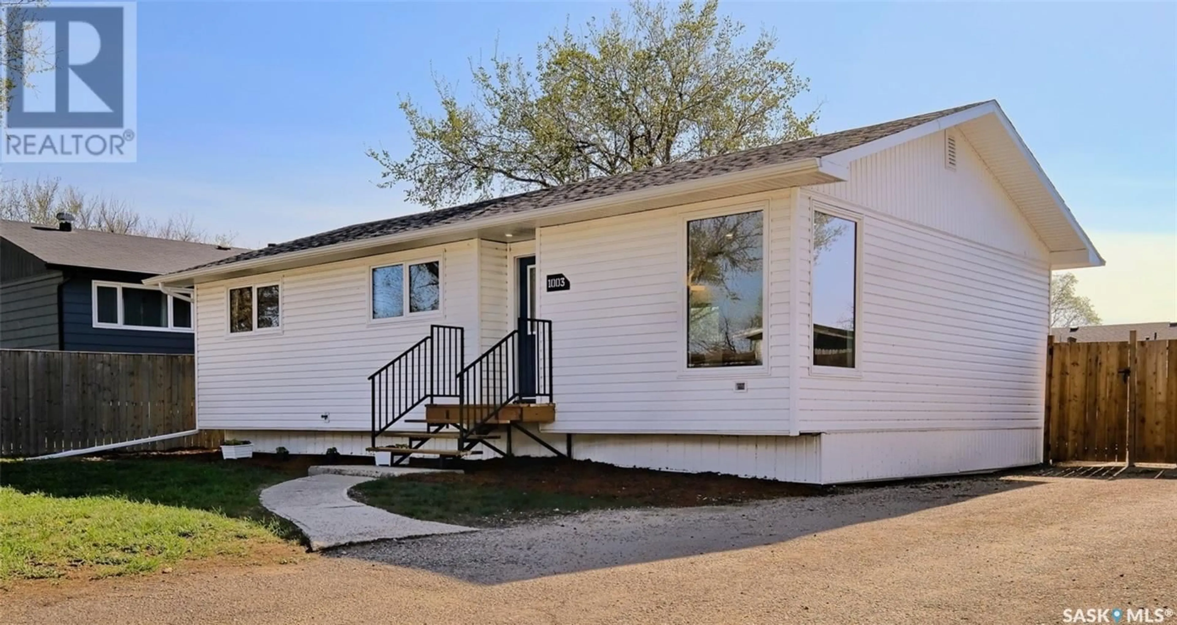Home with vinyl exterior material, street for 1003 THRASHER STREET, Rosetown Saskatchewan S0L2V0