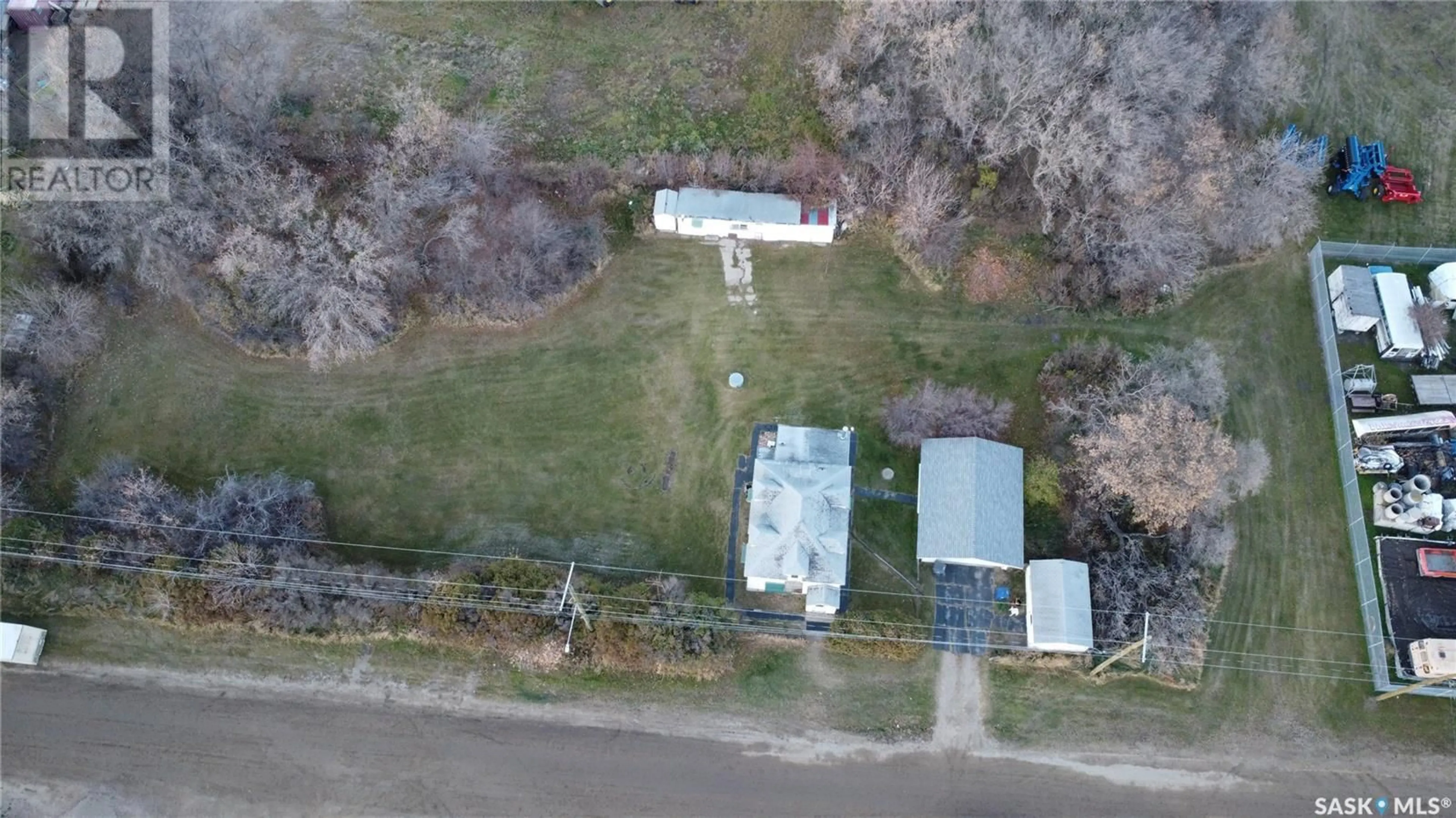 Frontside or backside of a home, the fenced backyard for 912 3rd STREET E, Rosthern Saskatchewan S0K3R0