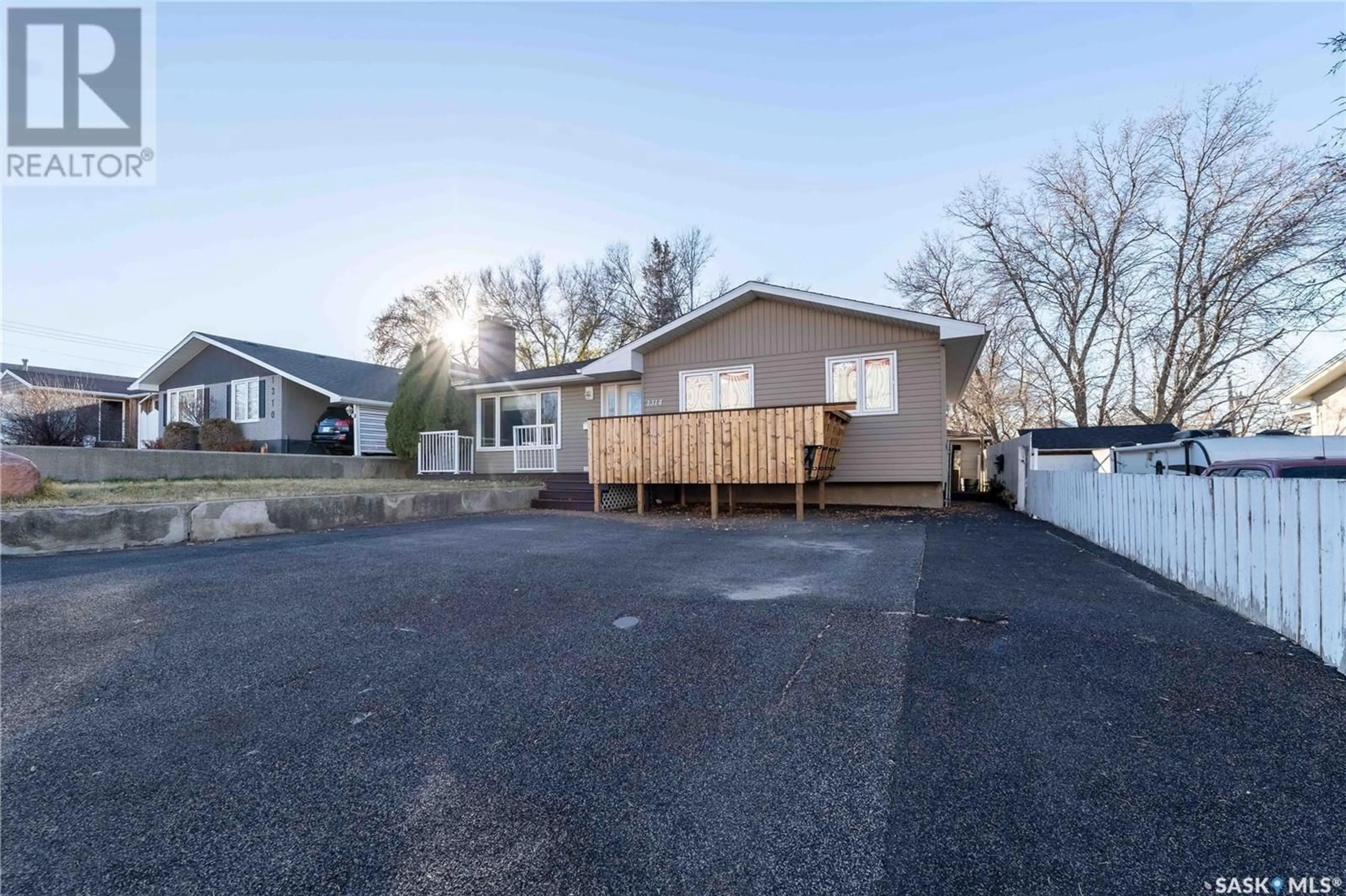 Frontside or backside of a home, the fenced backyard for 1314 Henleaze AVENUE, Moose Jaw Saskatchewan S6H3W2