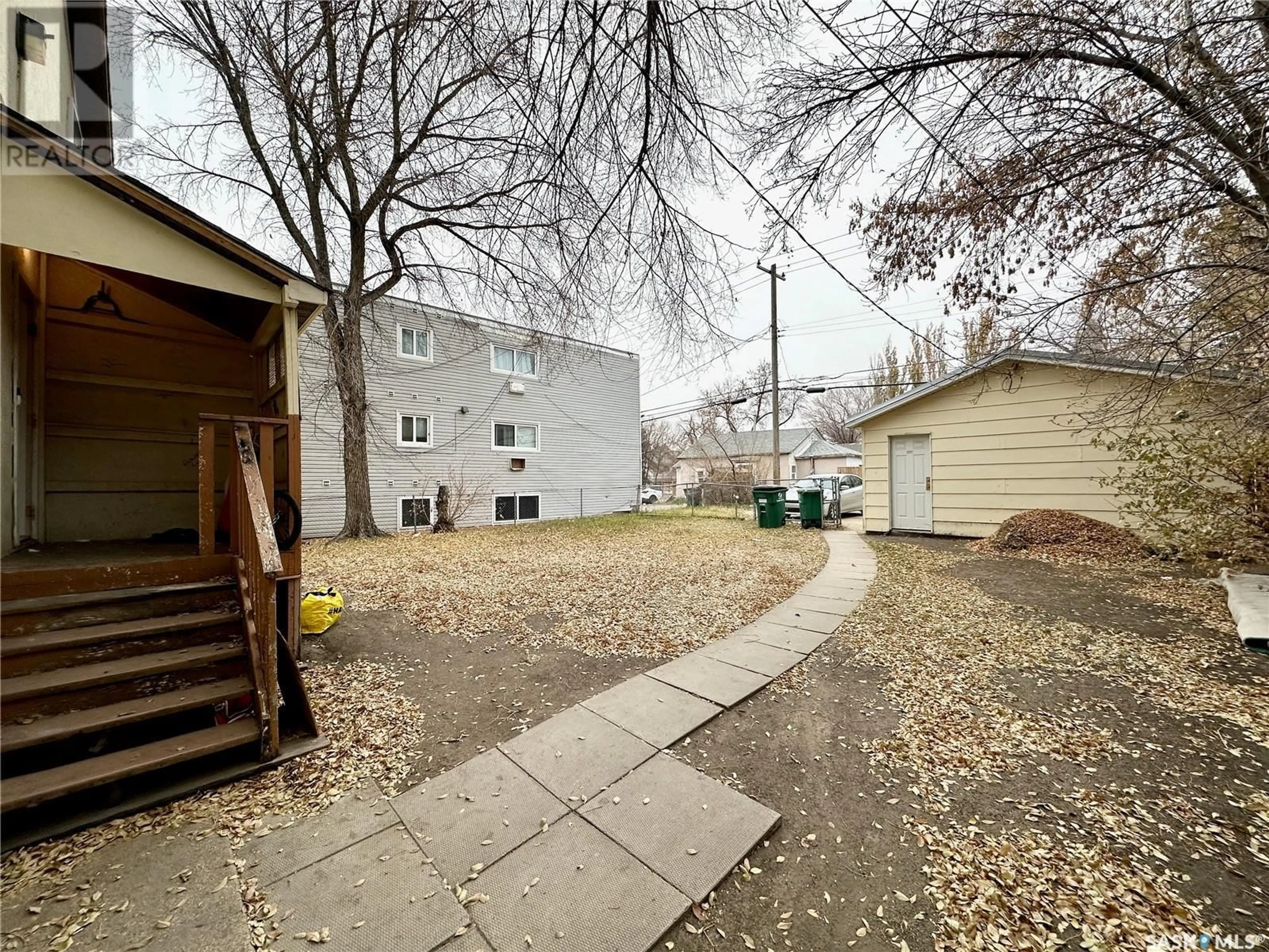 A pic from exterior of the house or condo, the fenced backyard for 1705 20th STREET W, Saskatoon Saskatchewan S7M0Z8