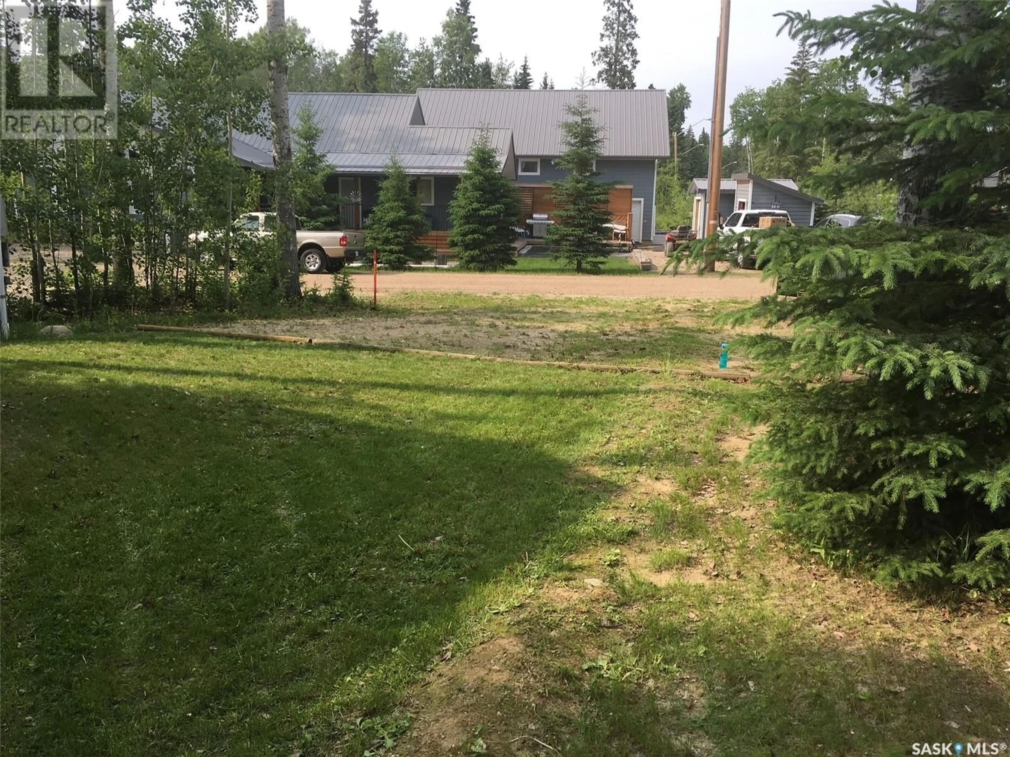 Frontside or backside of a home, the fenced backyard for C21 150 Okema Beach ROAD, Emma Lake Saskatchewan S0J0N0