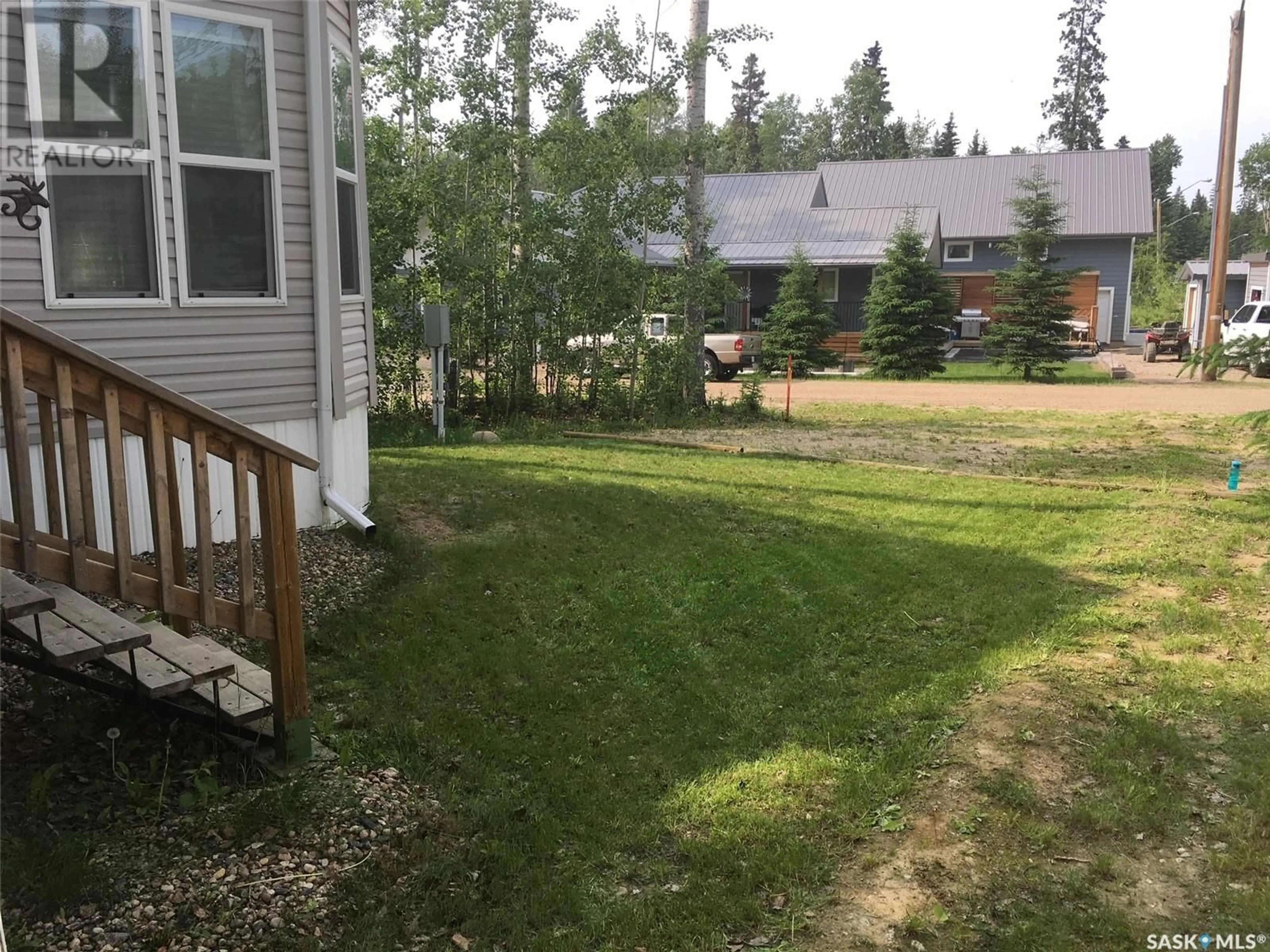 A pic from exterior of the house or condo, the fenced backyard for C21 150 Okema Beach ROAD, Emma Lake Saskatchewan S0J0N0