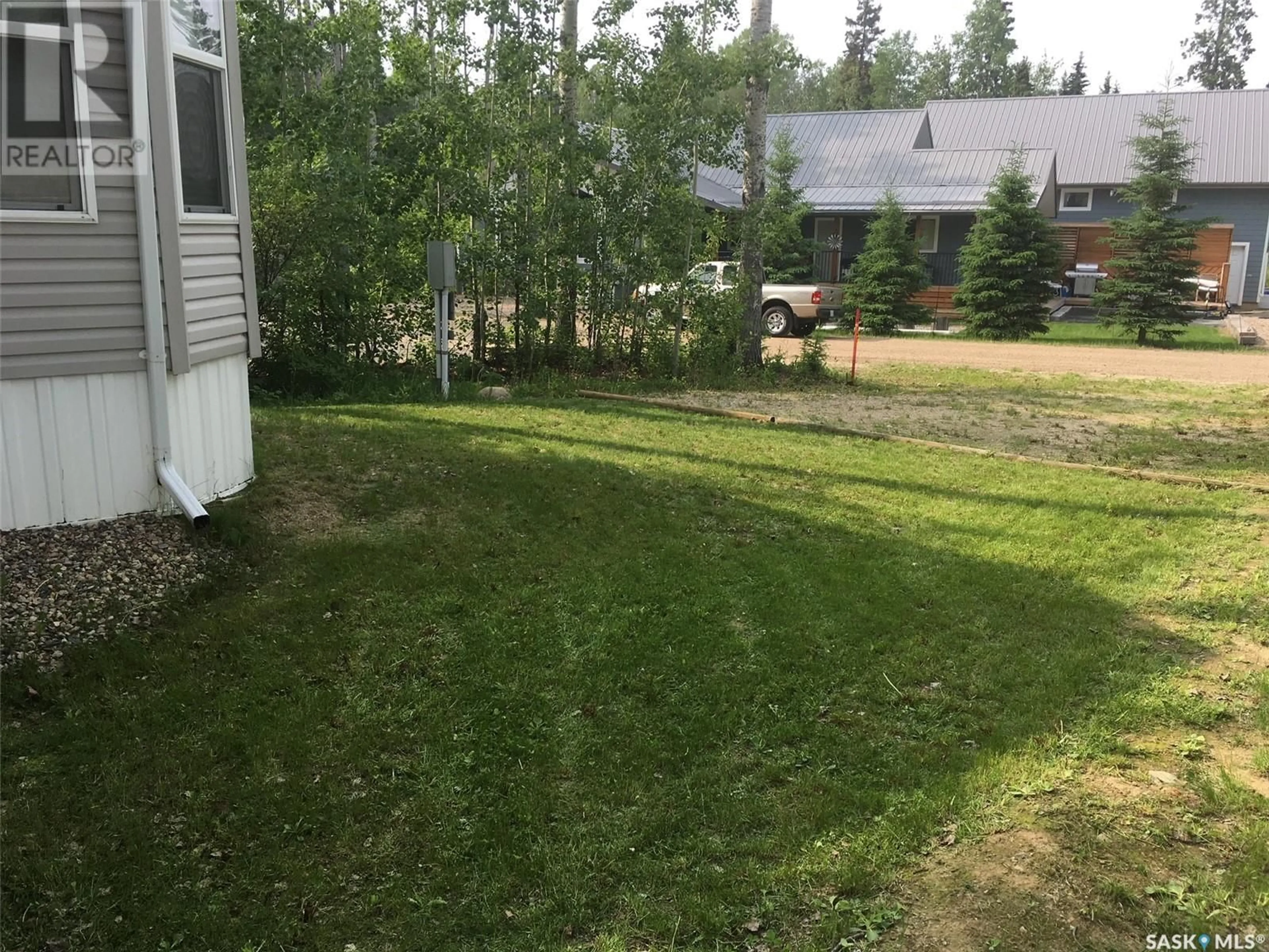 A pic from exterior of the house or condo, the fenced backyard for C21 150 Okema Beach ROAD, Emma Lake Saskatchewan S0J0N0