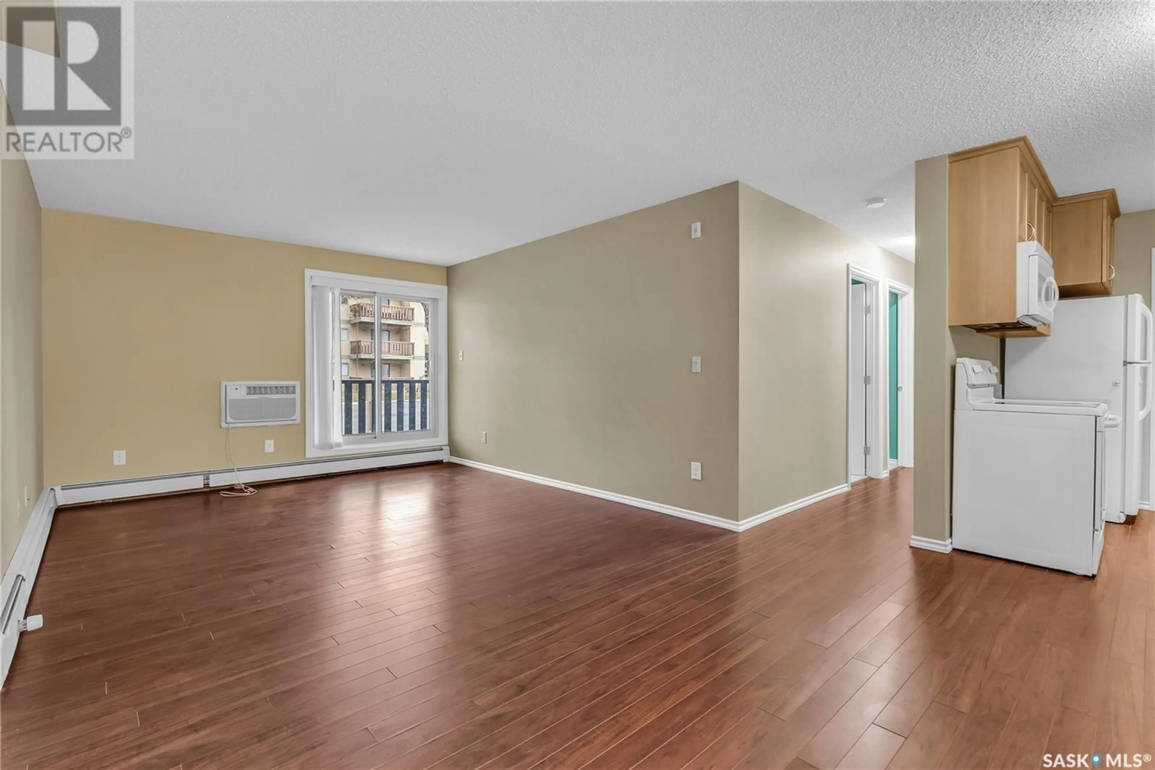 A pic of a room, wood floors for 104F 1121 McKercher DRIVE, Saskatoon Saskatchewan S7H5B8