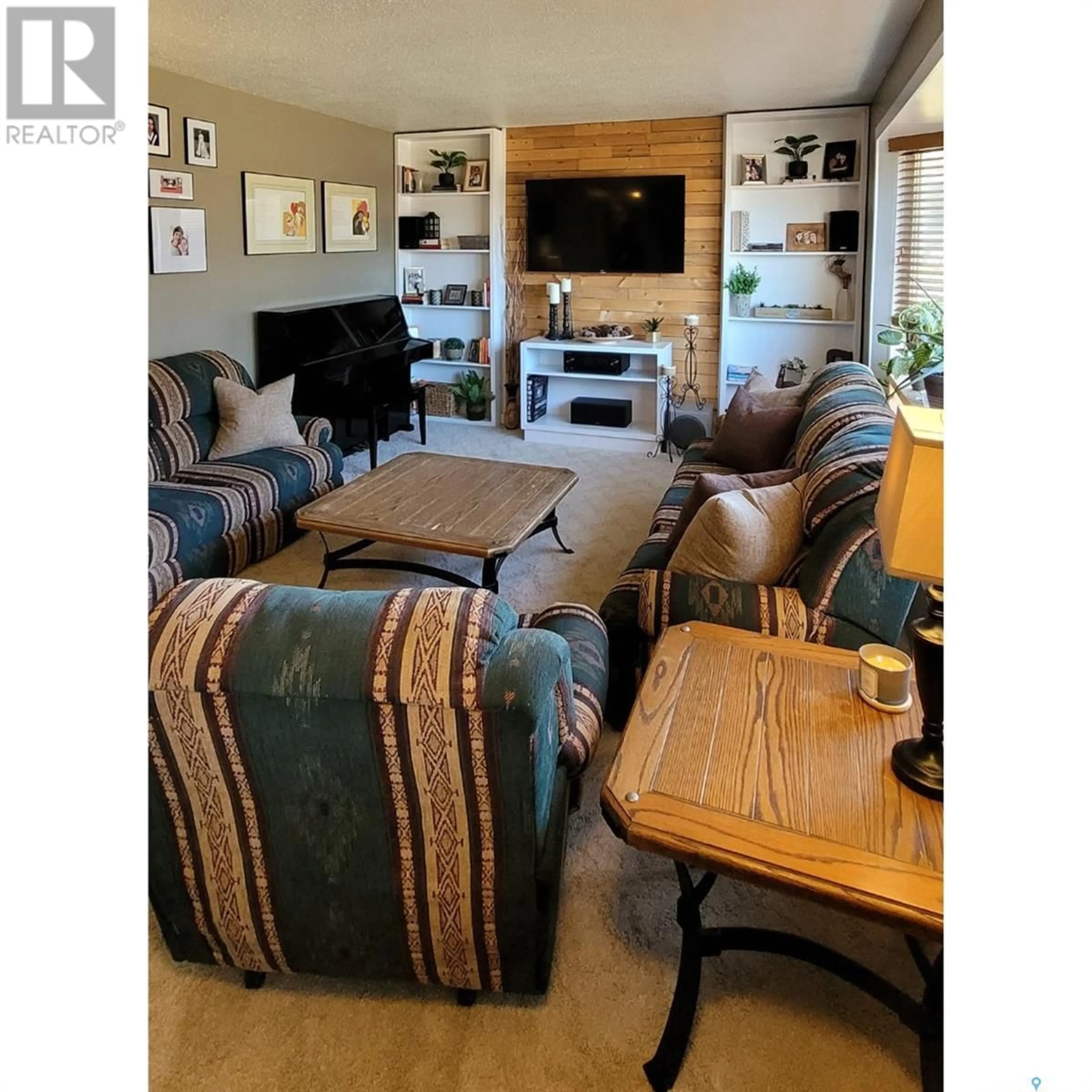 Living room with furniture, wood/laminate floor for 704 RAILWAY AVENUE, Loon Lake Saskatchewan S0M1L0