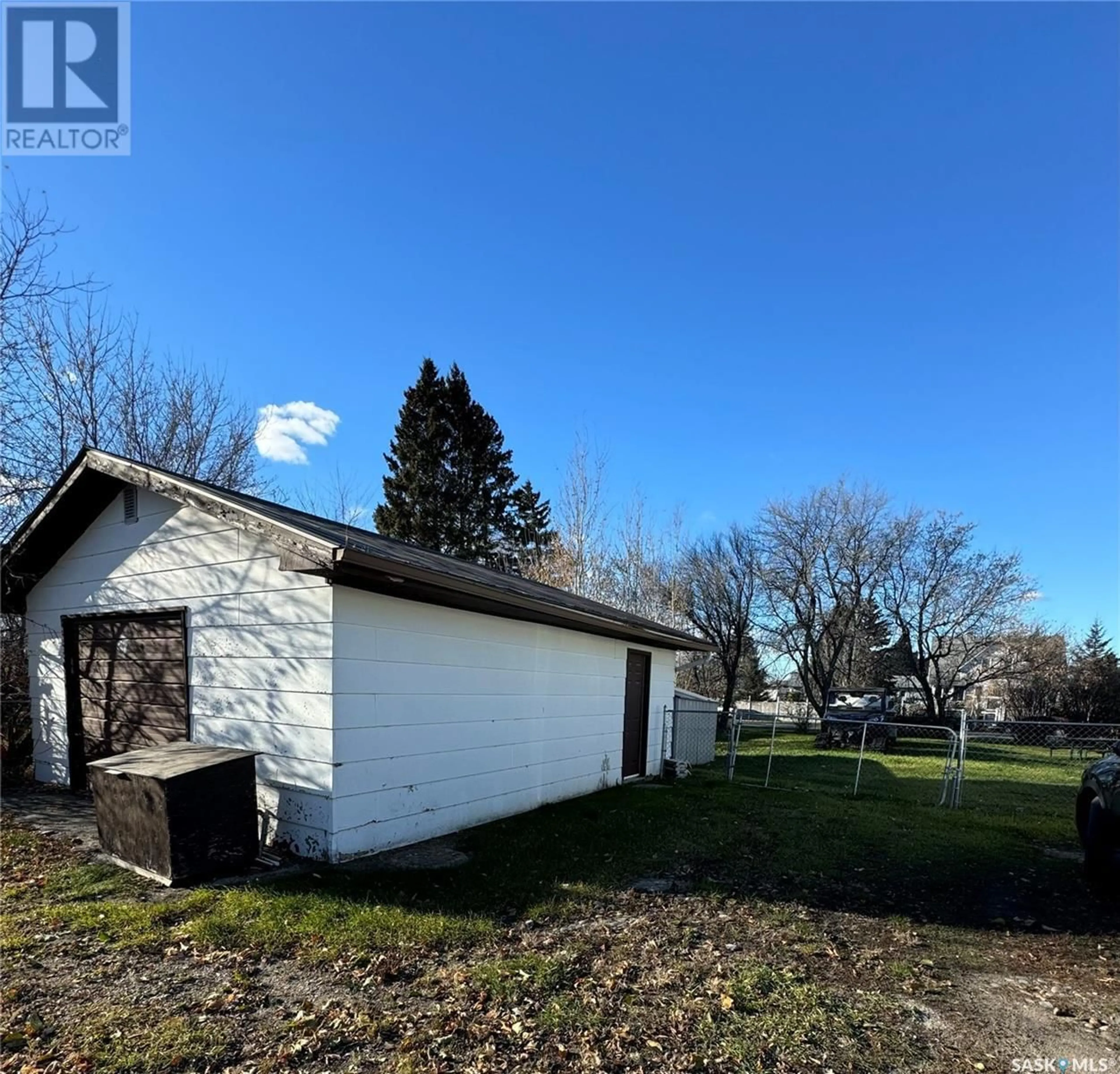 Frontside or backside of a home, the fenced backyard for 202 Hudson STREET, Hudson Bay Saskatchewan S0E0Y0