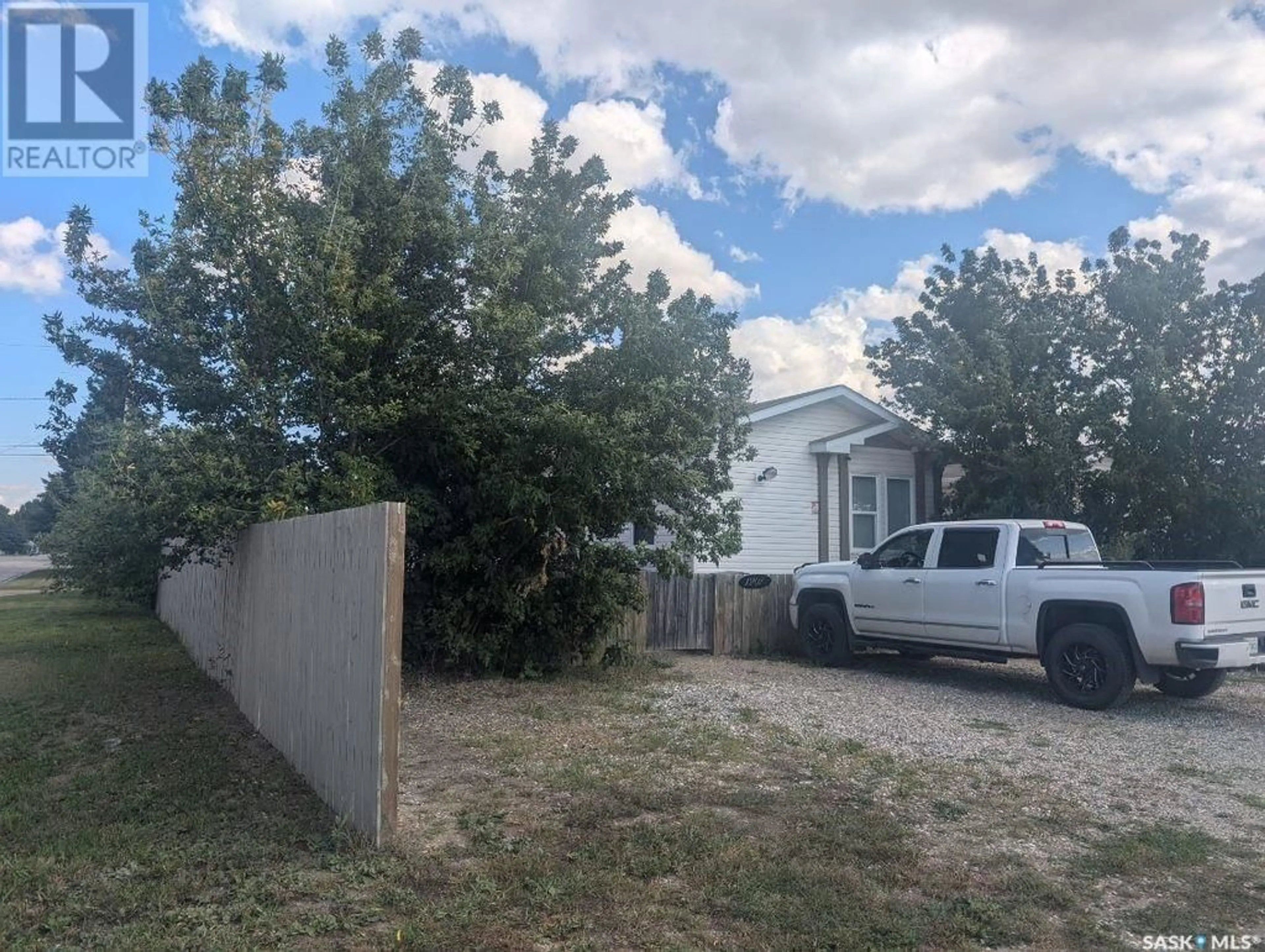 Frontside or backside of a home, the fenced backyard for 1201 3rd STREET W, Nipawin Saskatchewan S0E1E0