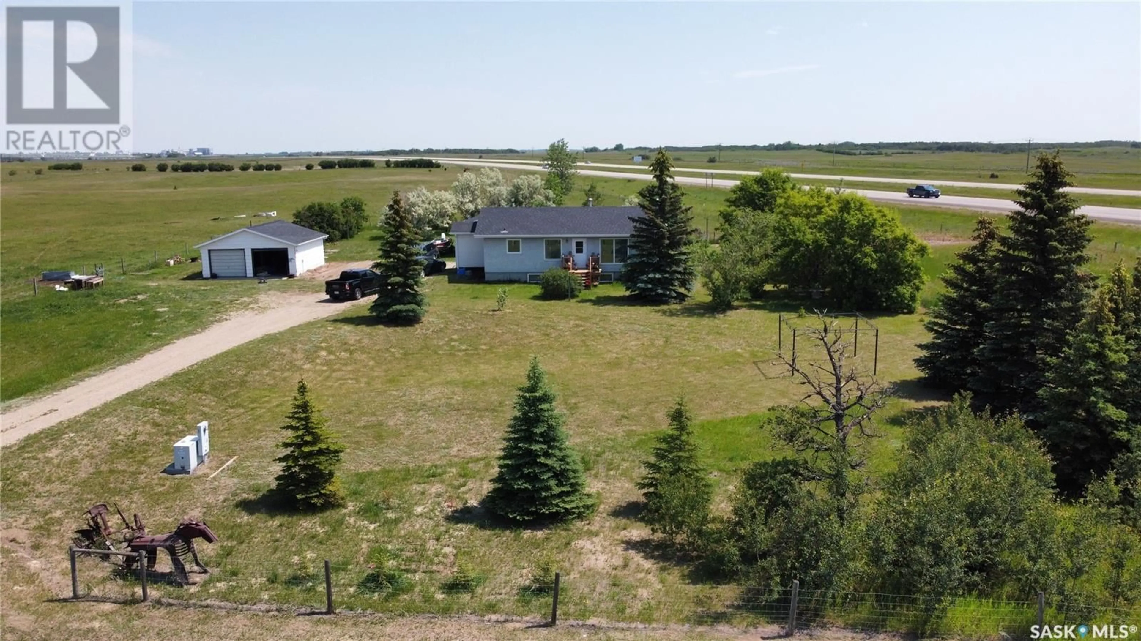 A pic from exterior of the house or condo, the fenced backyard for NW01-35-08-W3 Prairie Lane ROAD, Vanscoy Rm No. 345 Saskatchewan S0L3J0